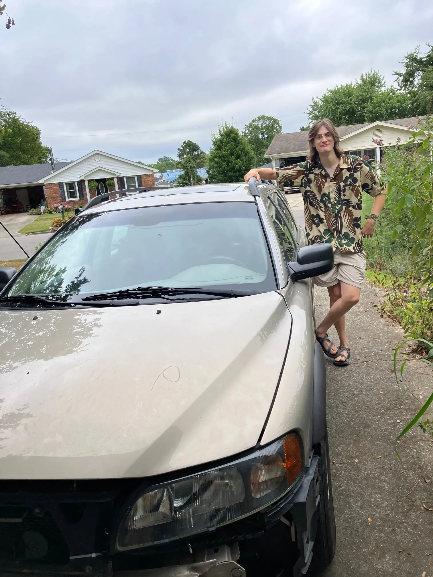 Young man posing with car