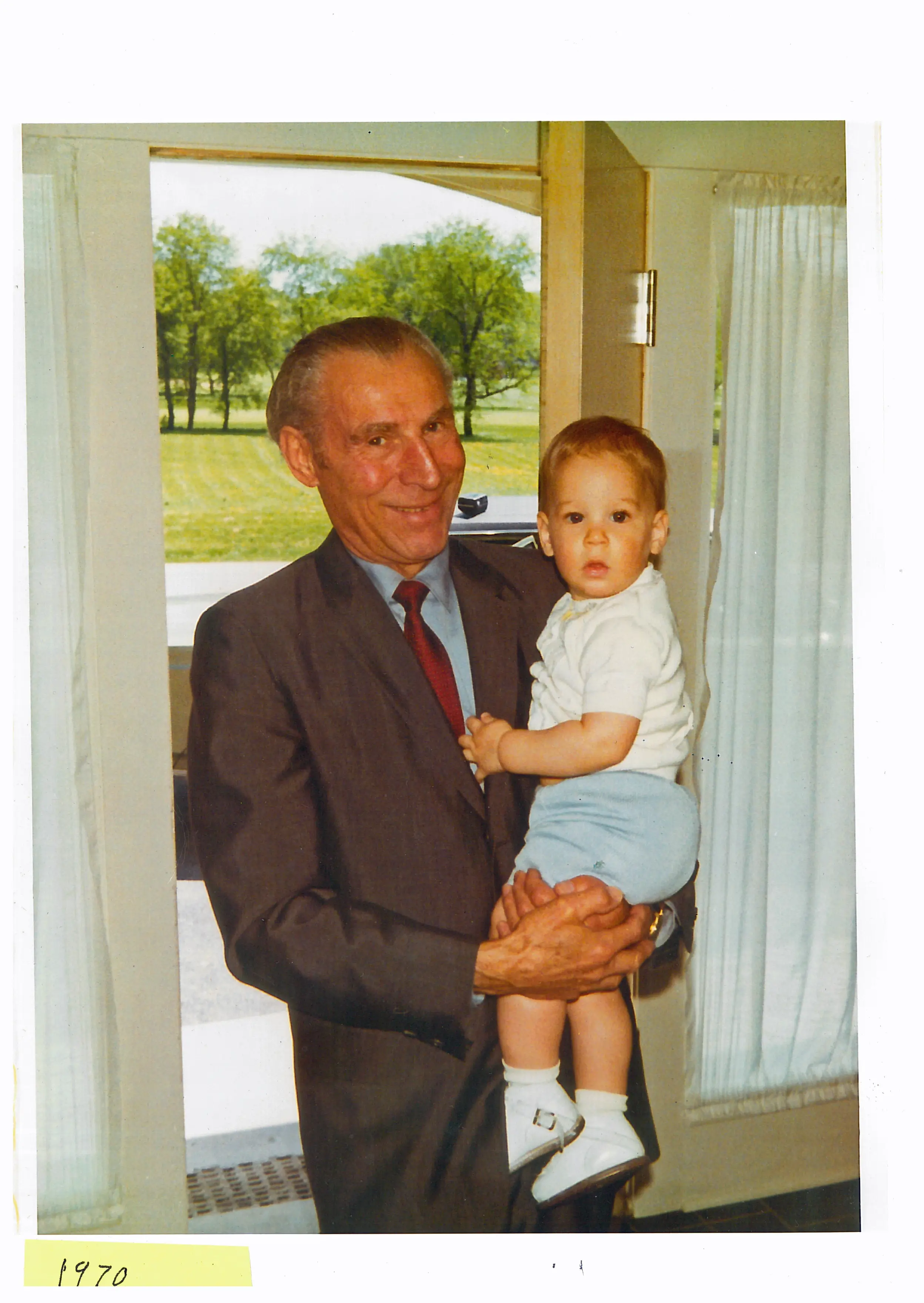 Family photo grandfather holding baby