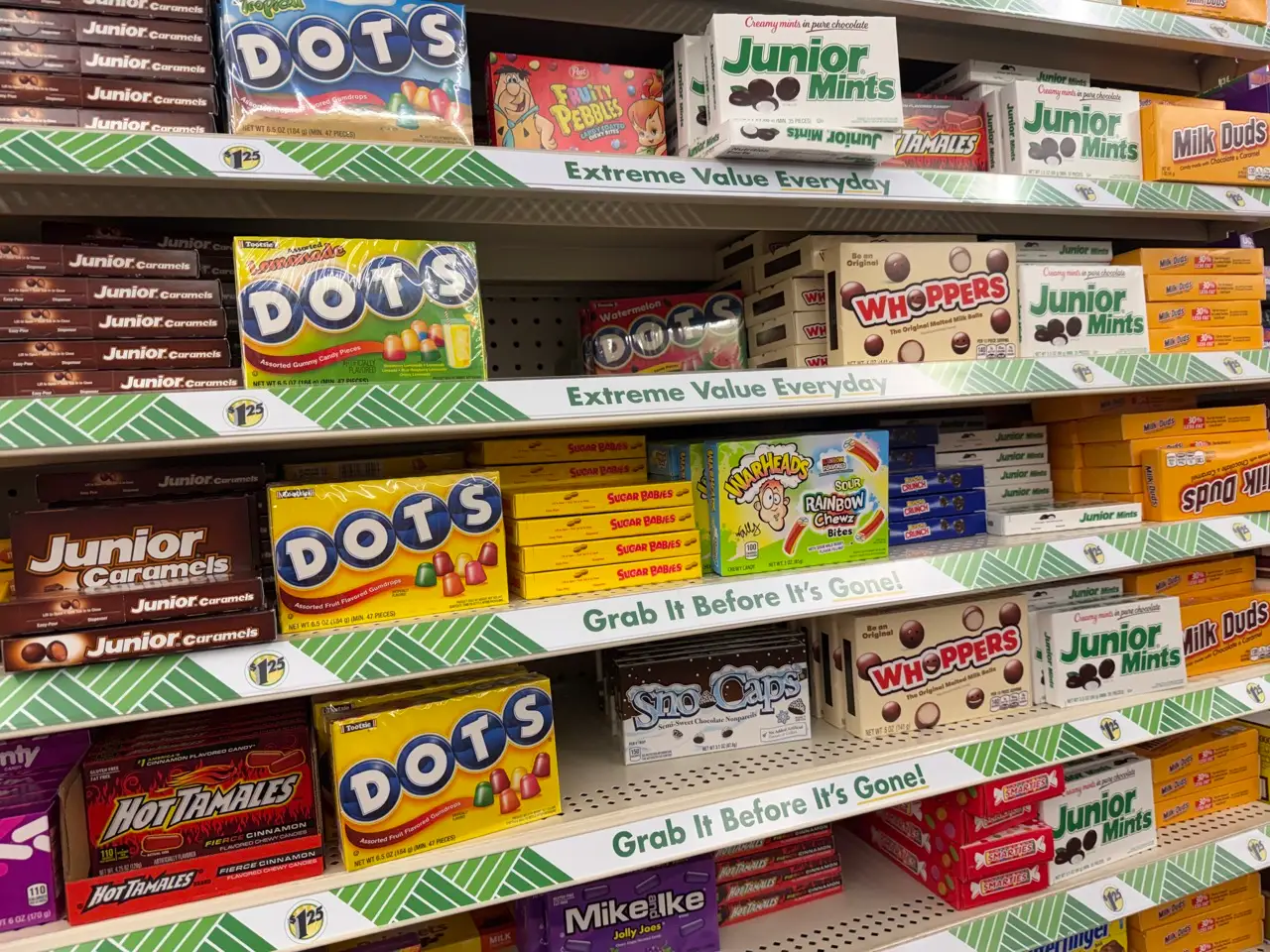 Boxed candies on shelves in aisle at Dollar Tree
