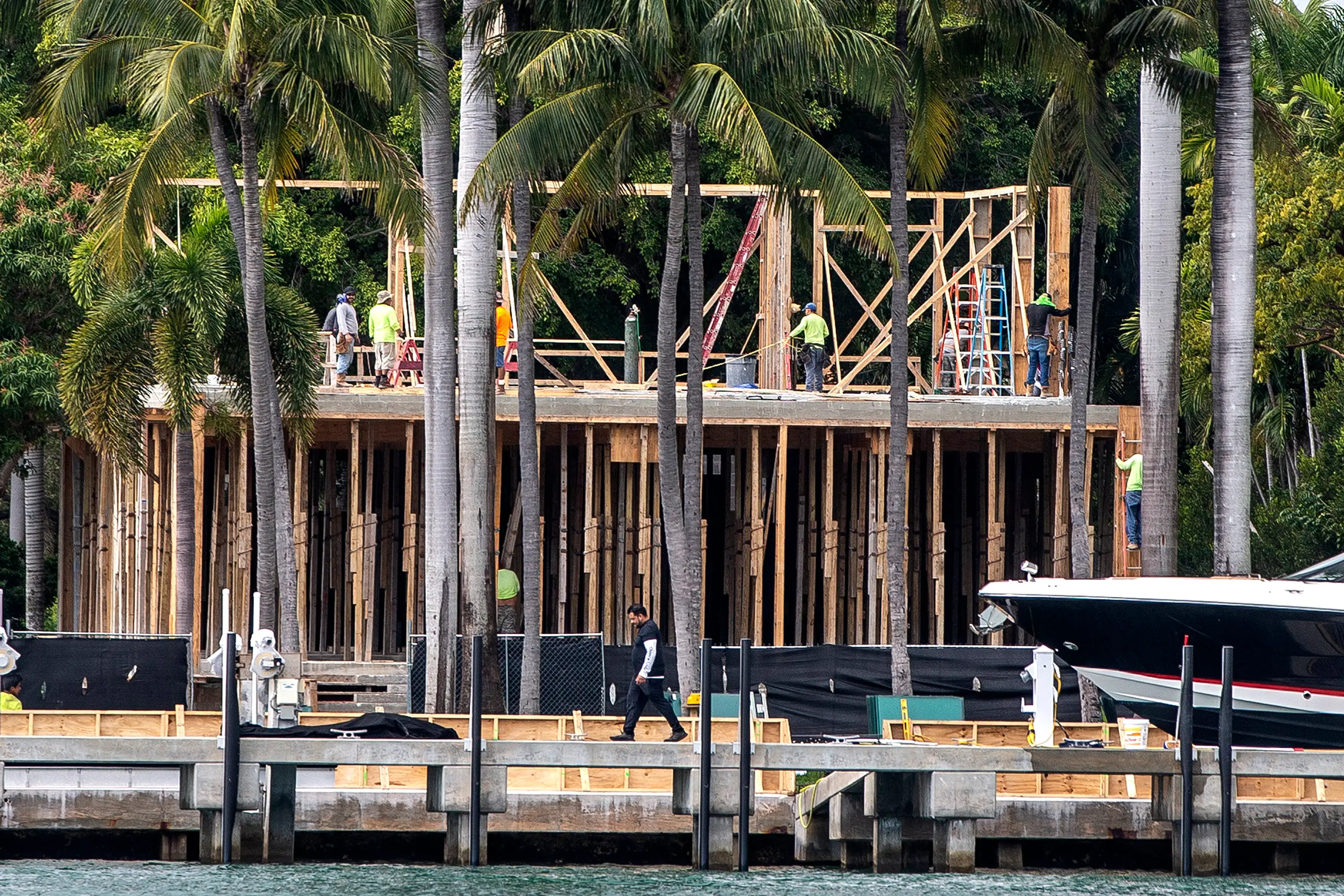 Construction workers building a mansion on Miami Beach.