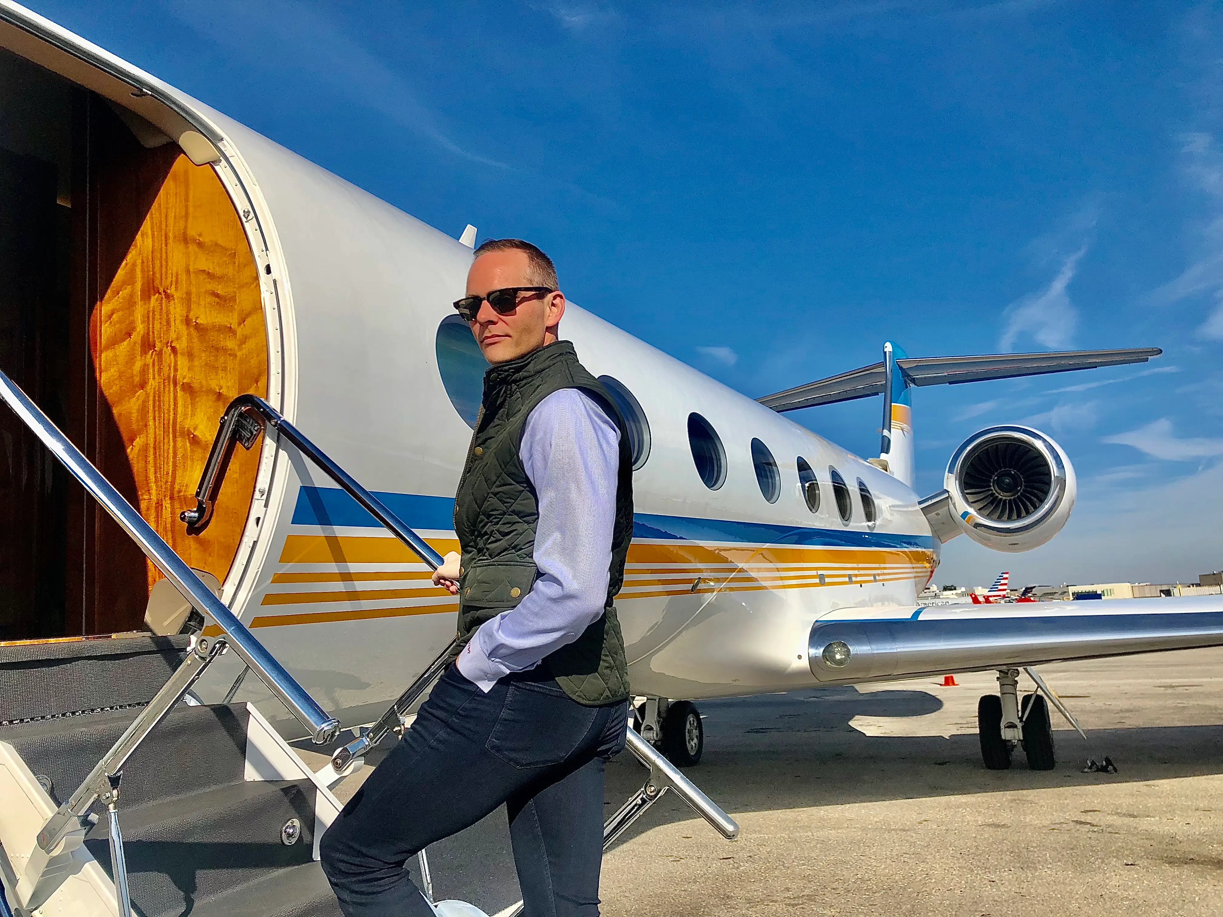 Gregg Brunson-Pitts on the stairs of a private jet.