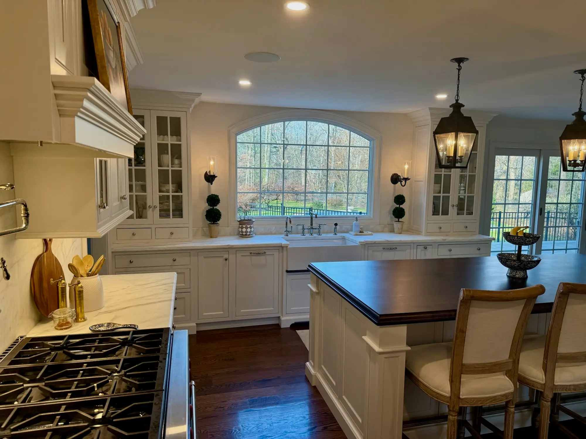A kitchen with a large, arced window above the sink.