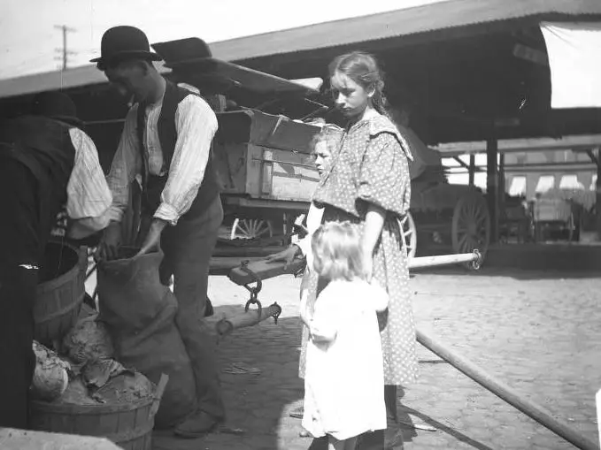 Two workers next to children.