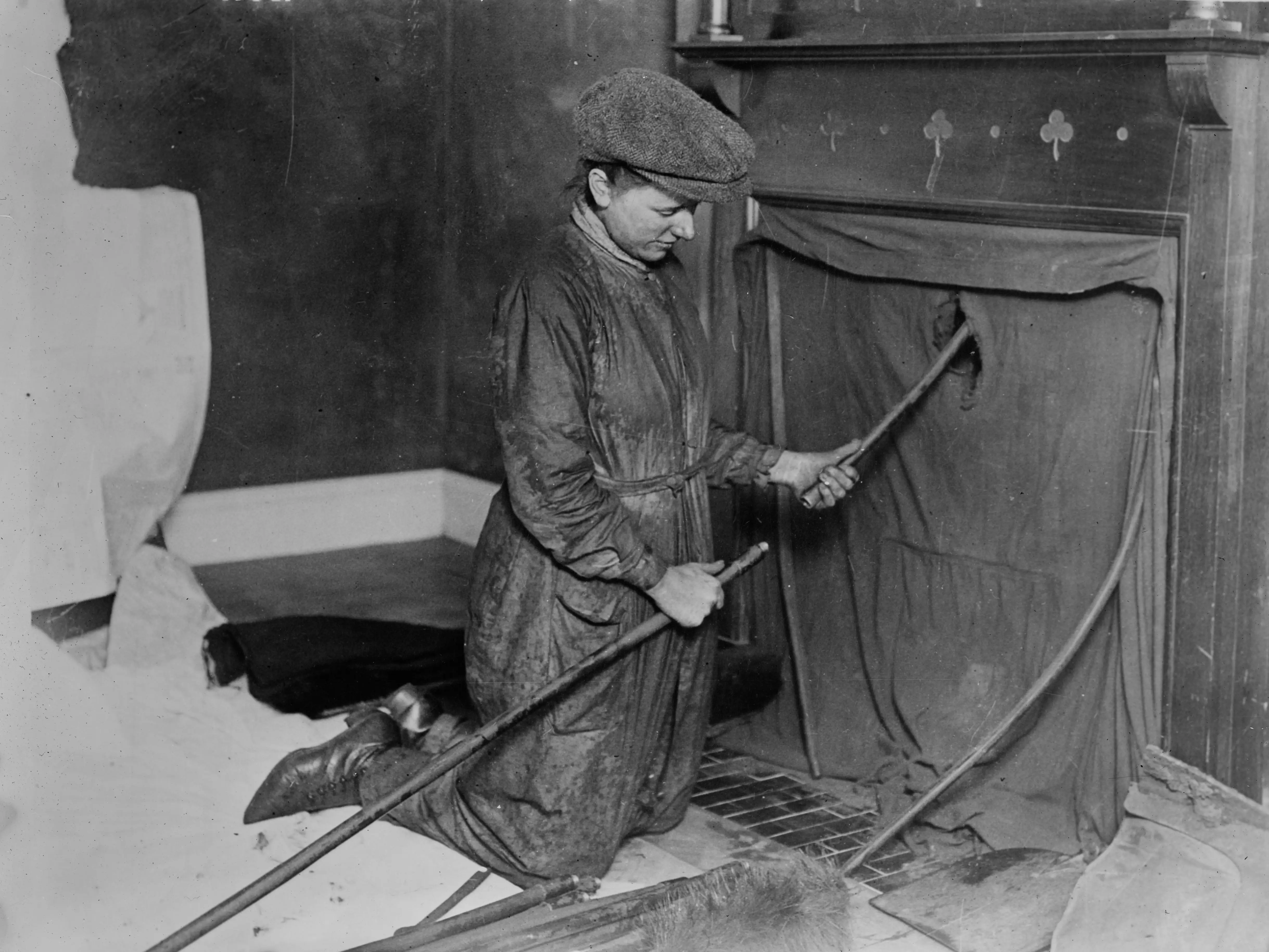 A woman cleaning a chimney.