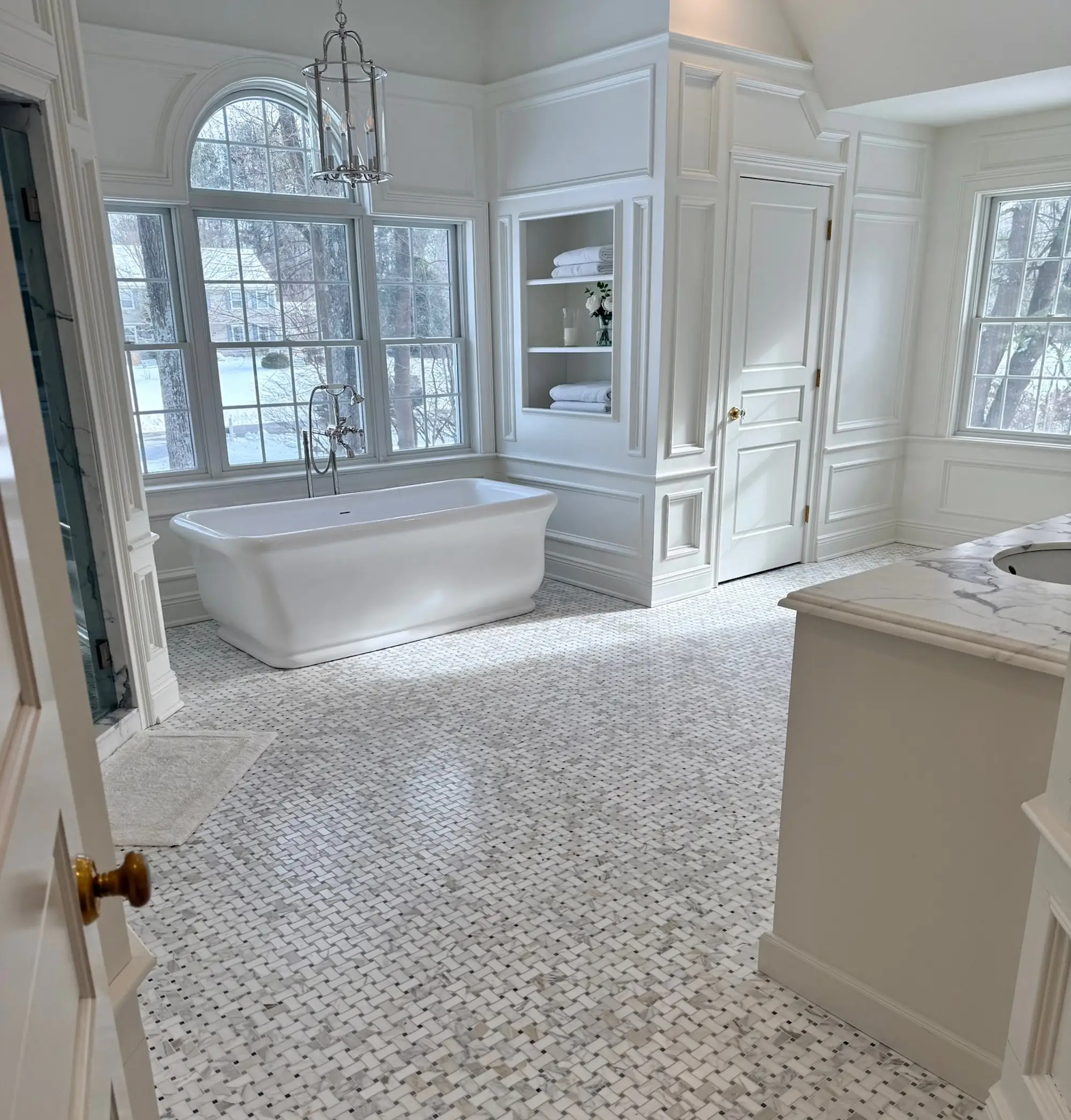 A large bathroom with a soaking tub and big windows.