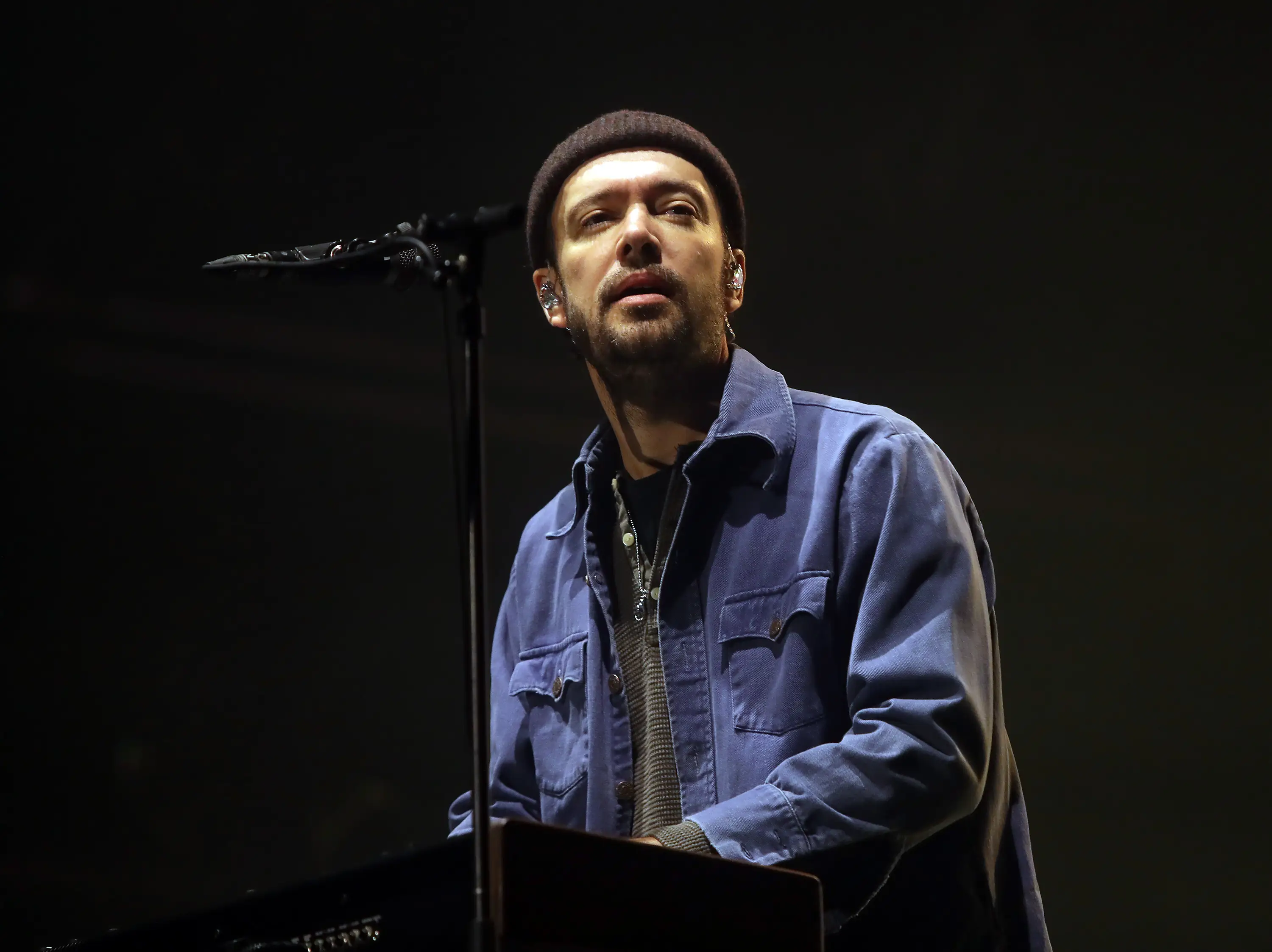 Ben Lovett of Mumford & Sons sits at a keyboard