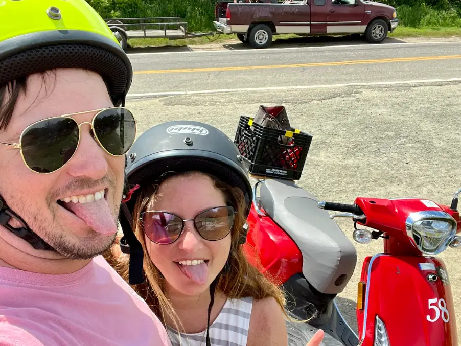 The writer and her husband sticking out their tongues in front of a motorcycle on Block Island, near Providence, Rhode Island.