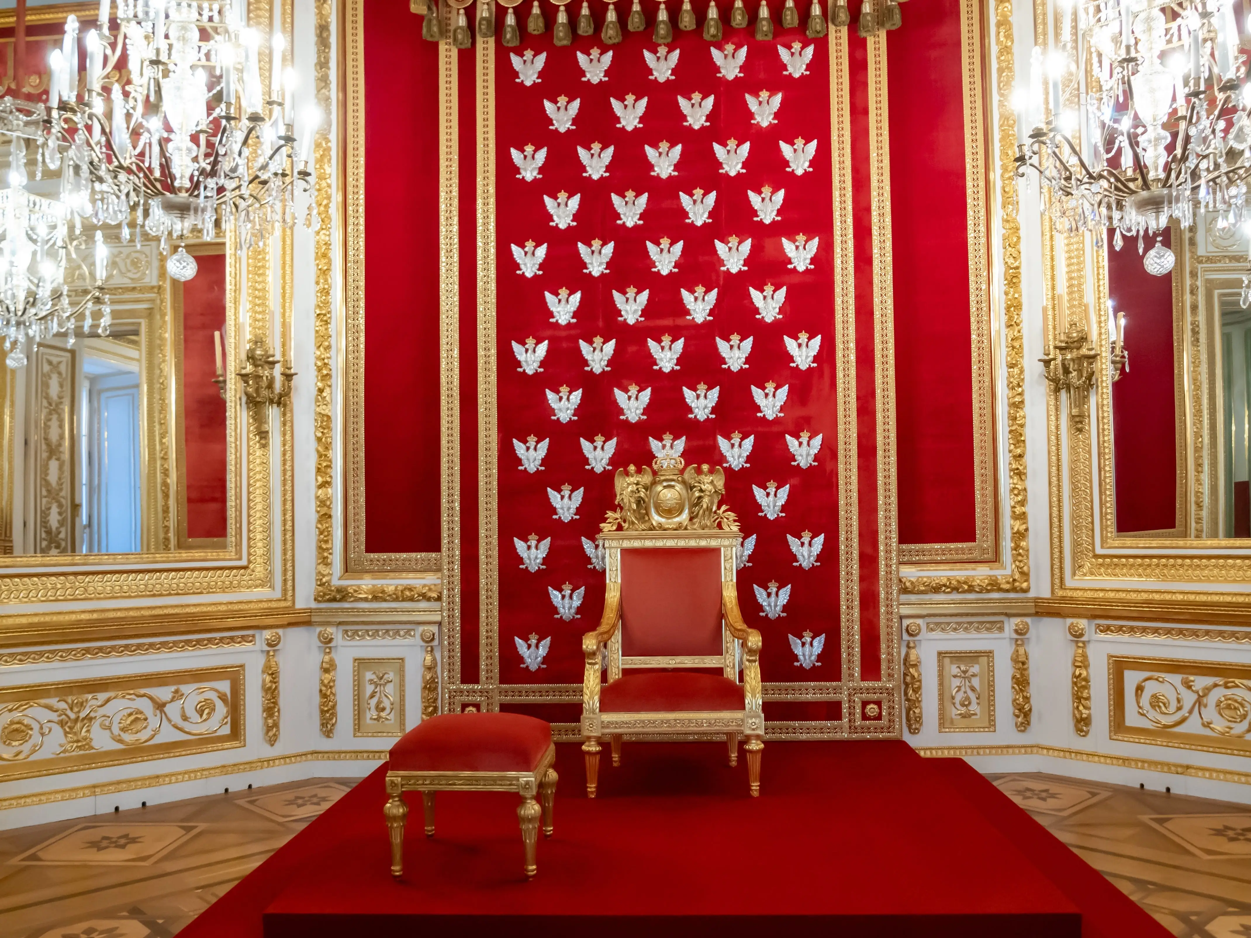 A king's throne next to a stool.