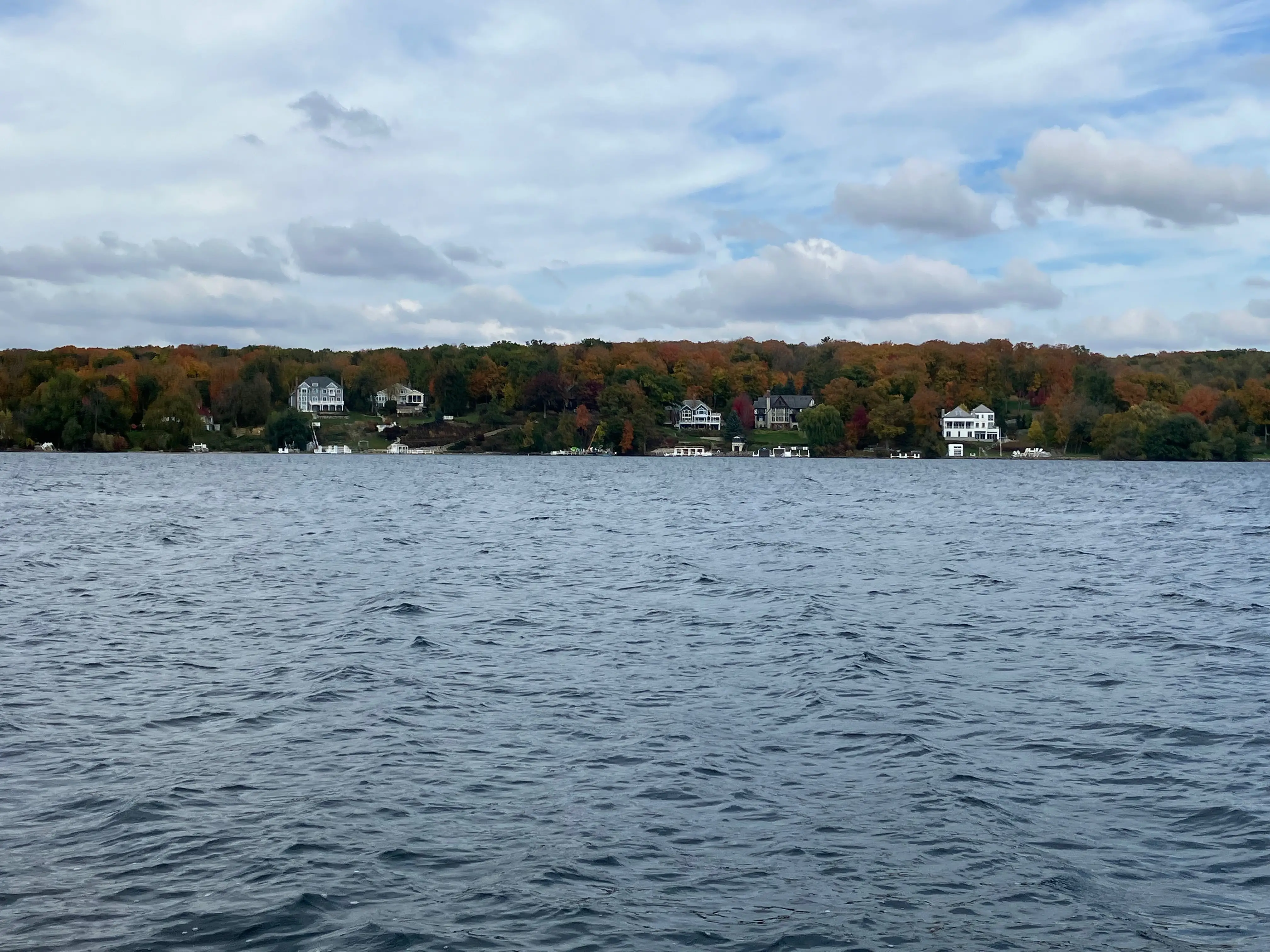 Fall foliage, houses along lakefront