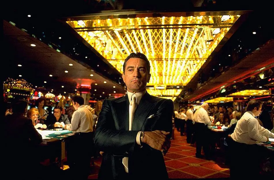 Robert De Niro arms crossed in a casino