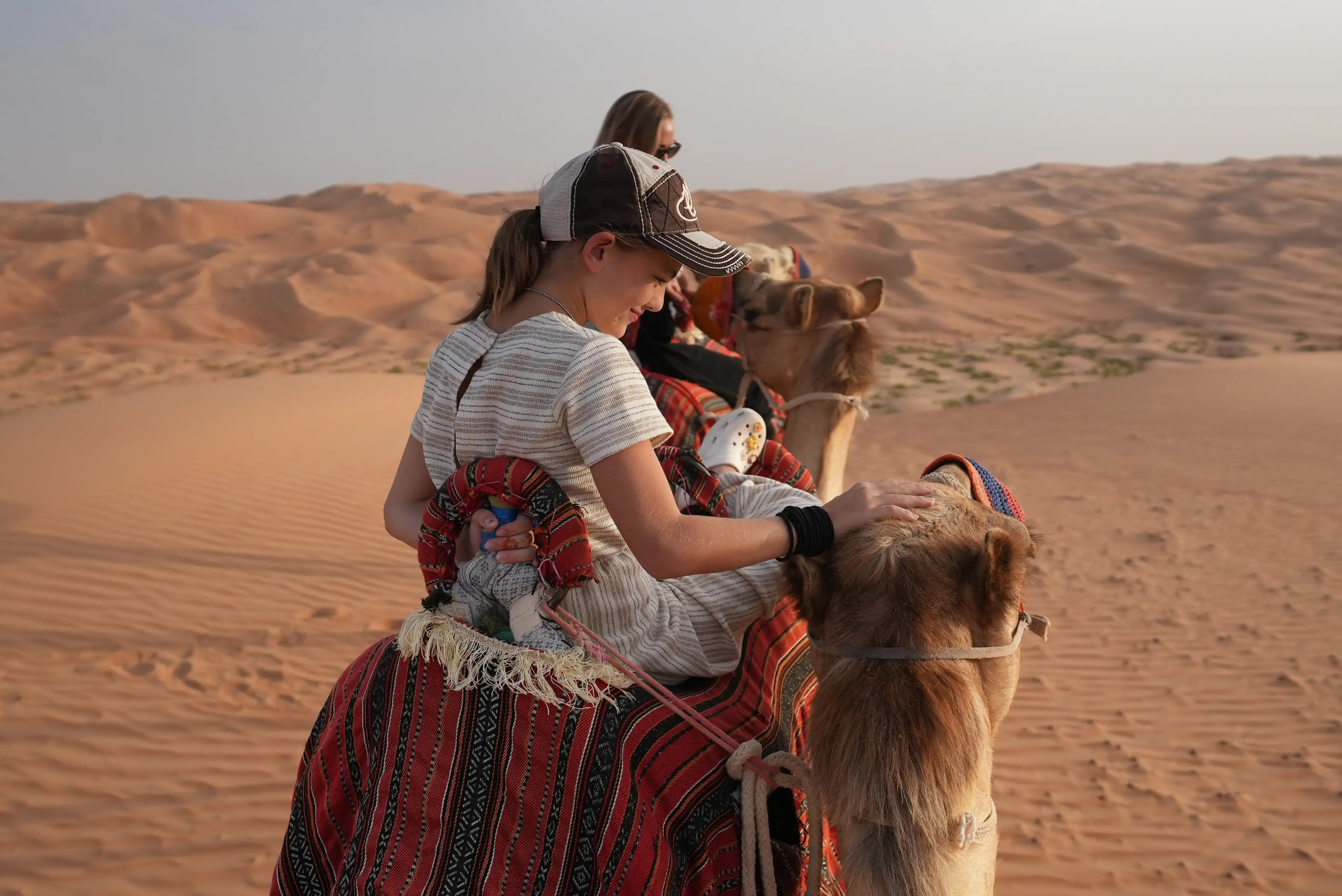 Child on camel in desert