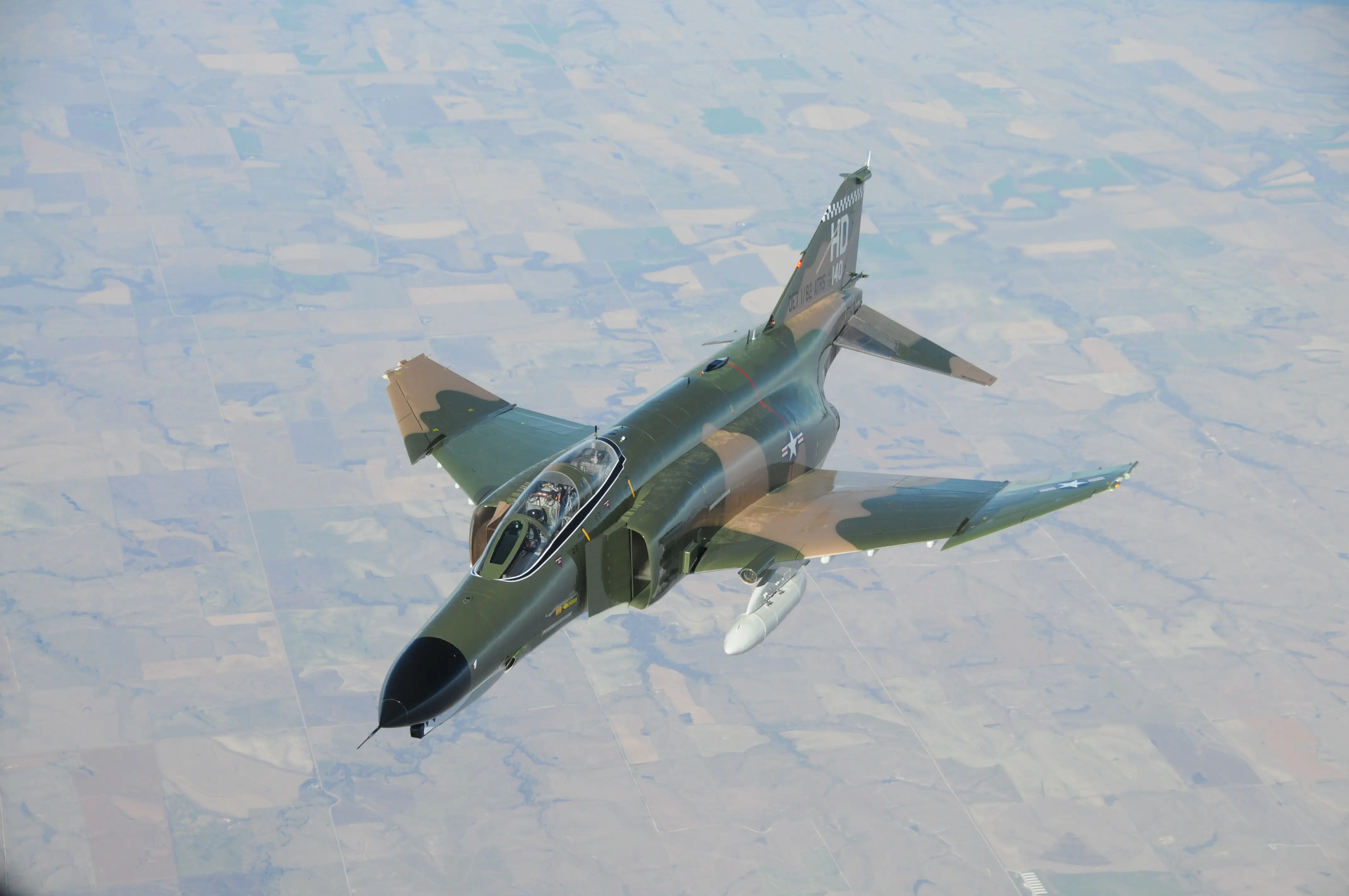 An F-4 Phantom II aircraft painted with a camouflage color scheme.