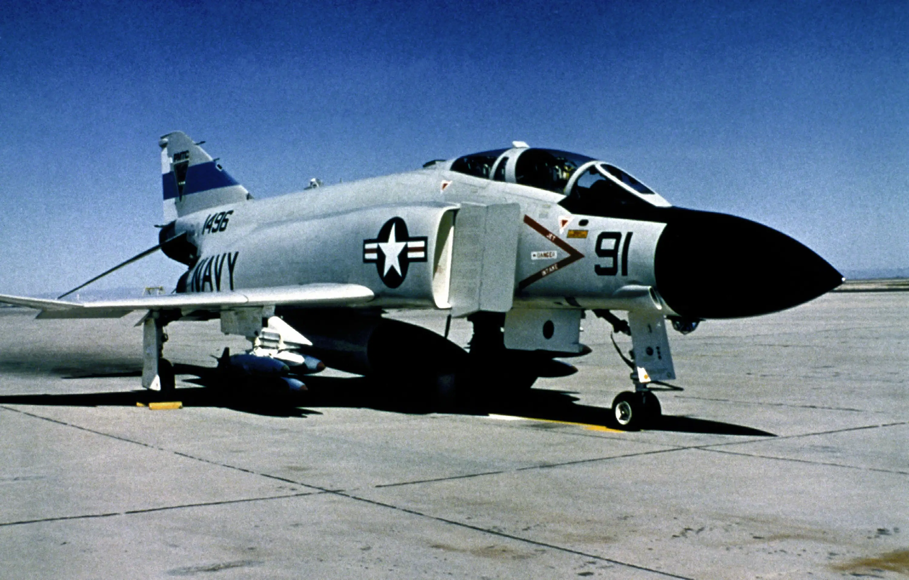 A F-4 Phantom II is seen sitting on tarmac.
