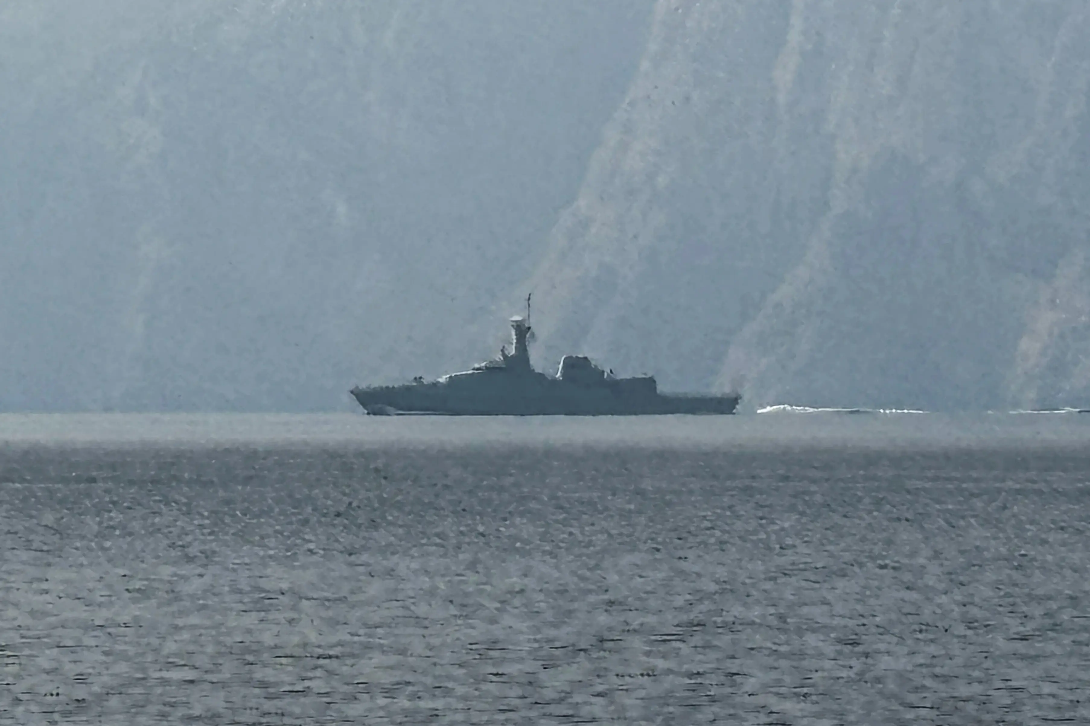A navy vessel is seen sailing in the Strait of Hormuz, a vital waterway through which much of the world's oil and gas passes, on March 1, 2026.