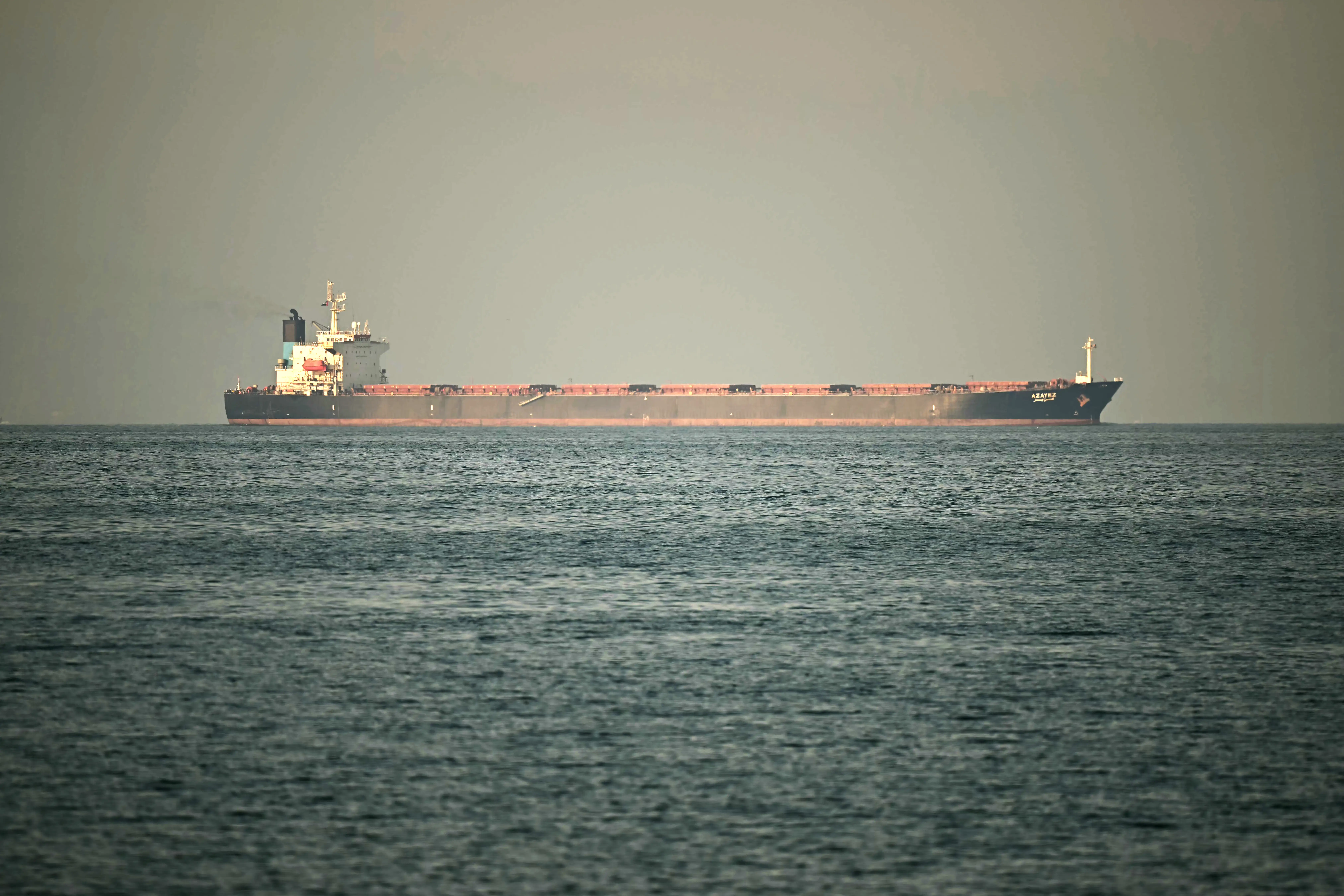 A cargo ship is pictured off the coast of the city of Fujairah, in the Strait of Hormuz in the northern Emirate on February 25, 2026.