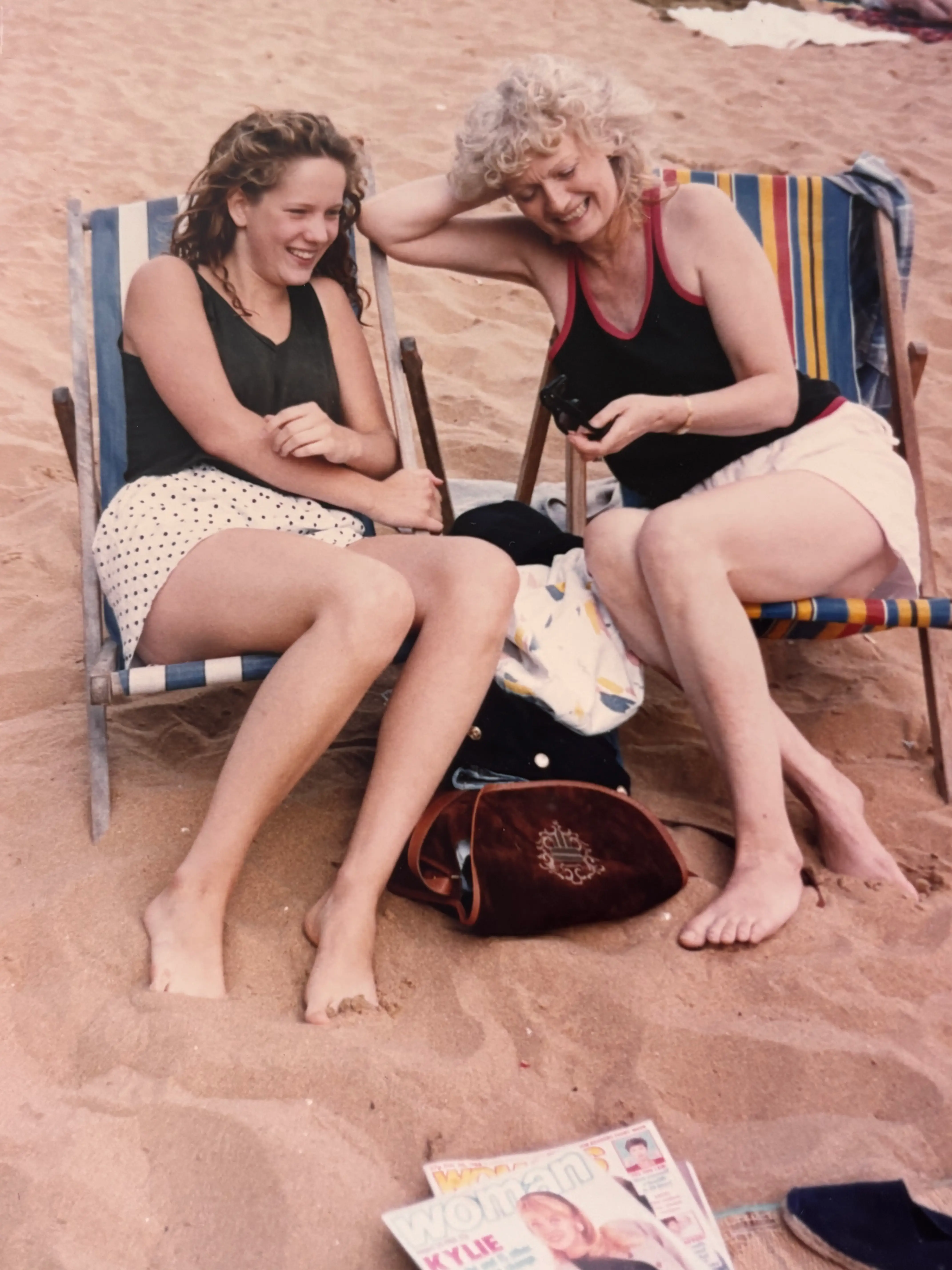 Mother and daughter on the beach together.