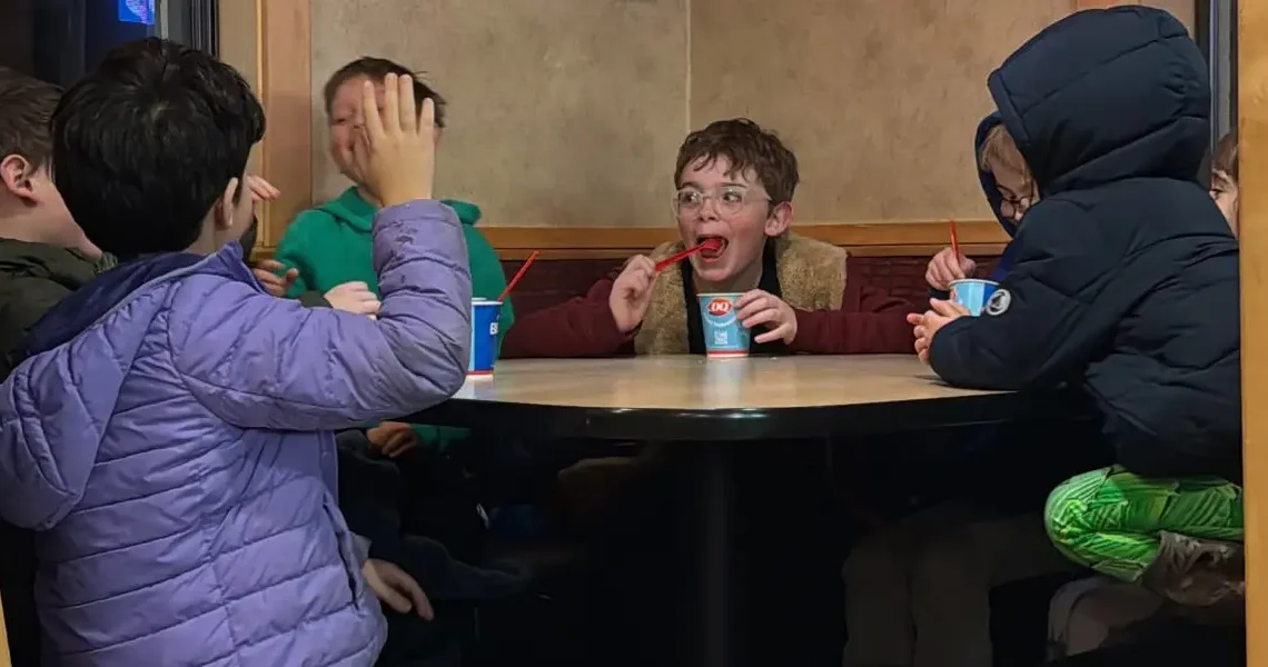 My 8-year-old invited his 4 best friends for dinner. I sat at a separate table and watched them have fun independently.