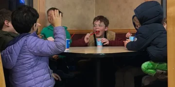 My 8-year-old invited his 4 best friends for dinner. I sat at a separate table and watched them have fun independently.