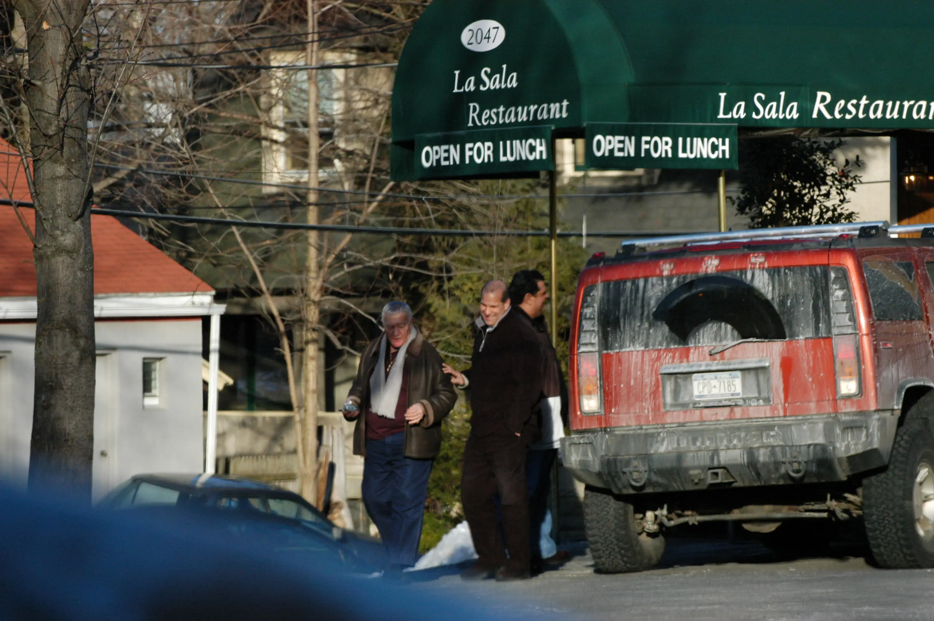 Distant photo of three guys outside of the La Sala Restaurant.