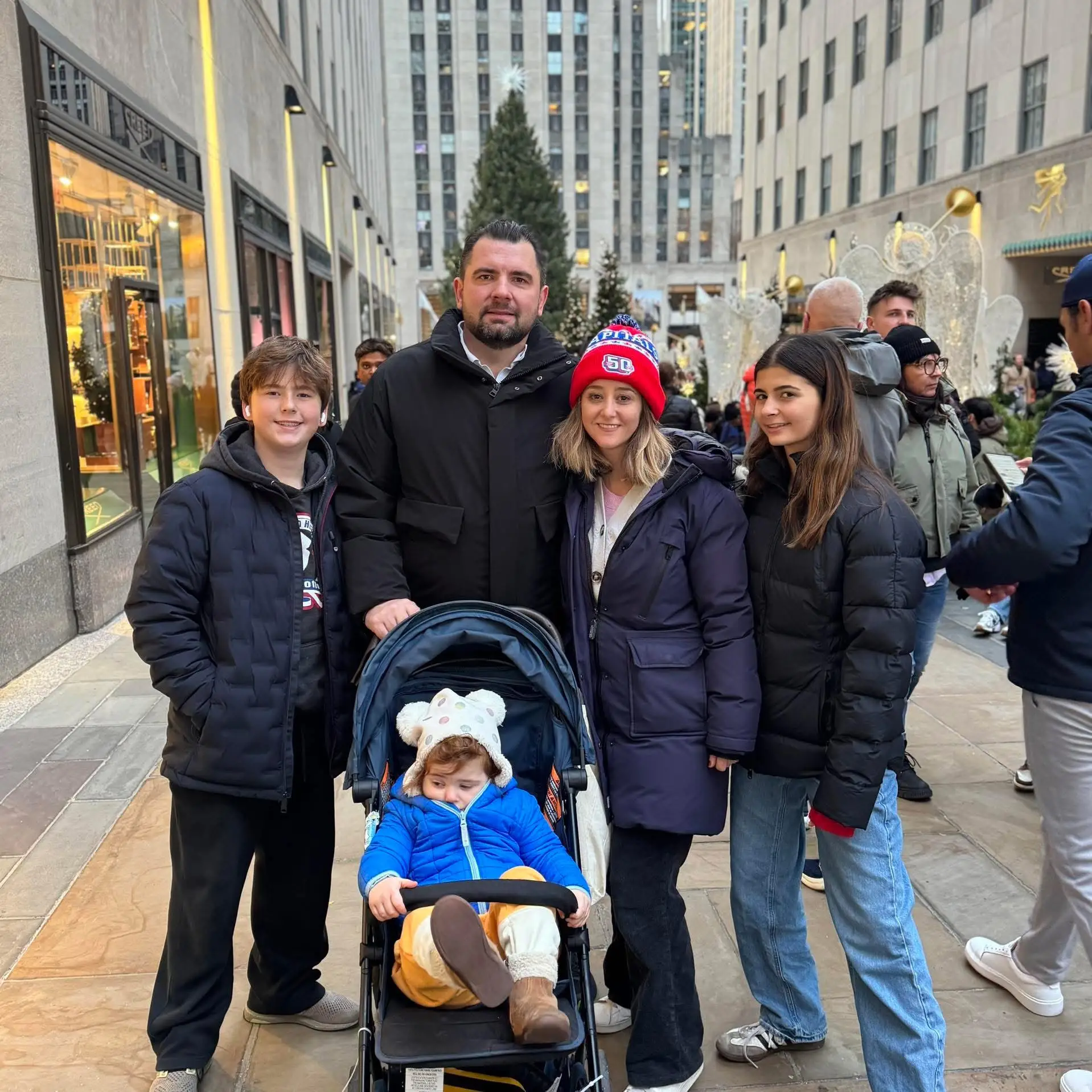 Family smiling in New York City in winter coats