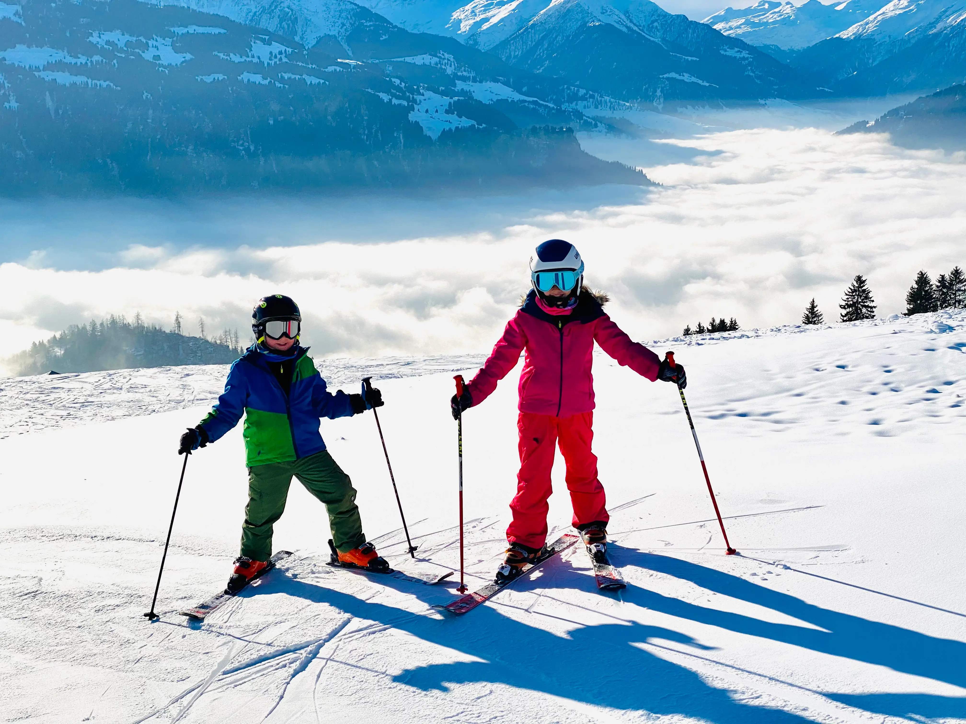 Two kids on skiis on snowy mountain