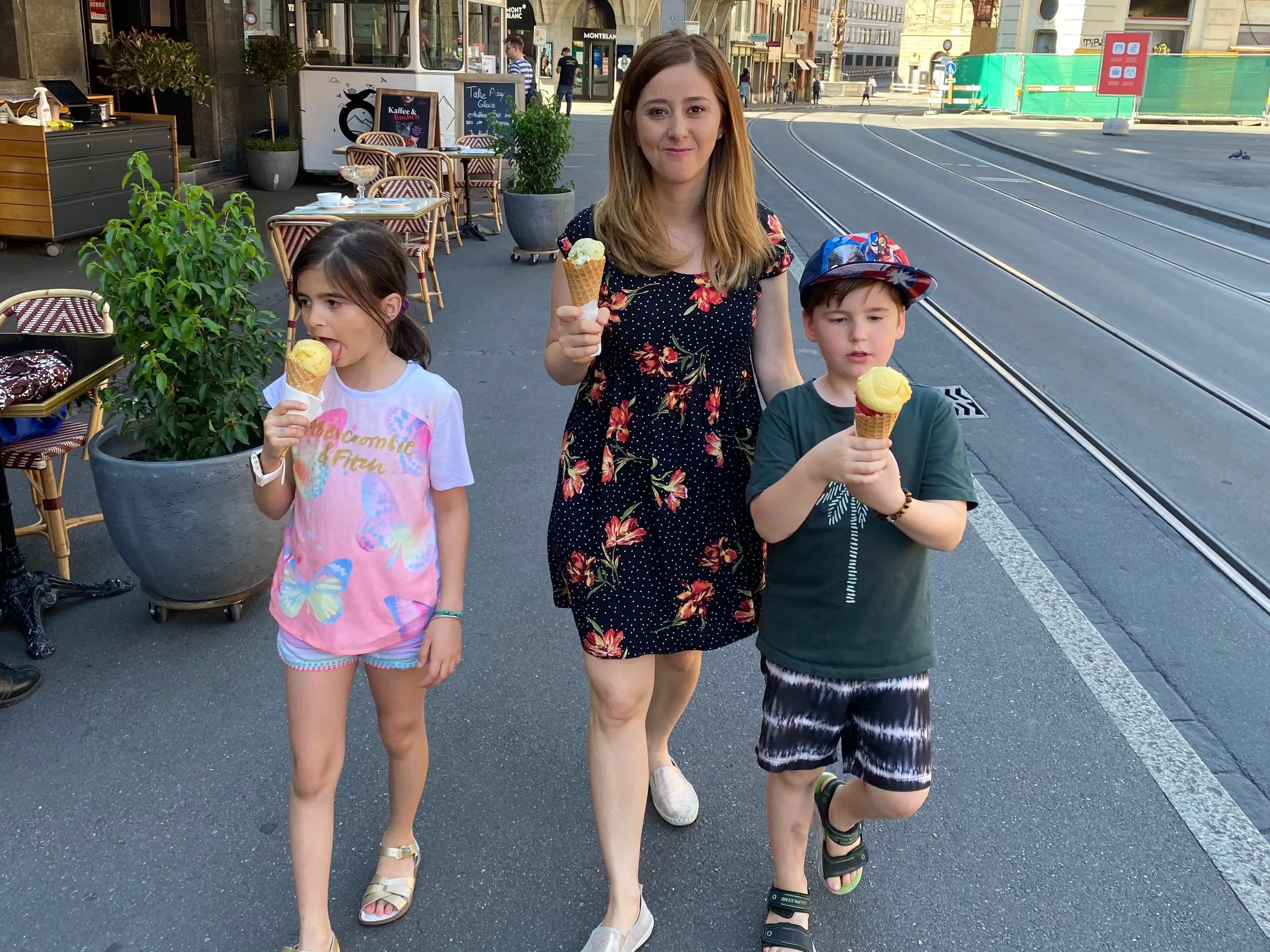 Family eating ice cream, walking down sidewalk