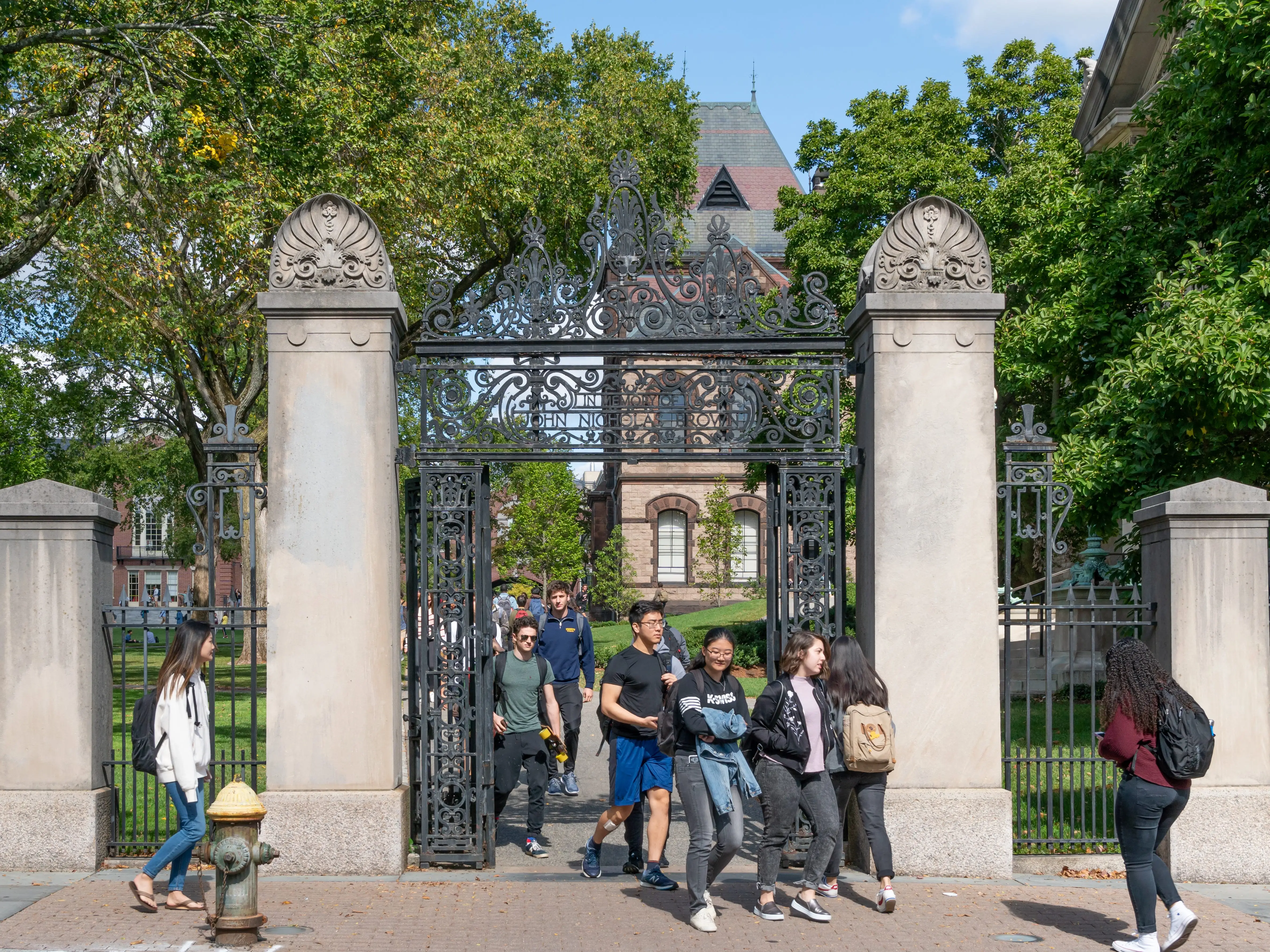 John Nicholas Brown Gates and unidentified individuals on the campus of Brown University.