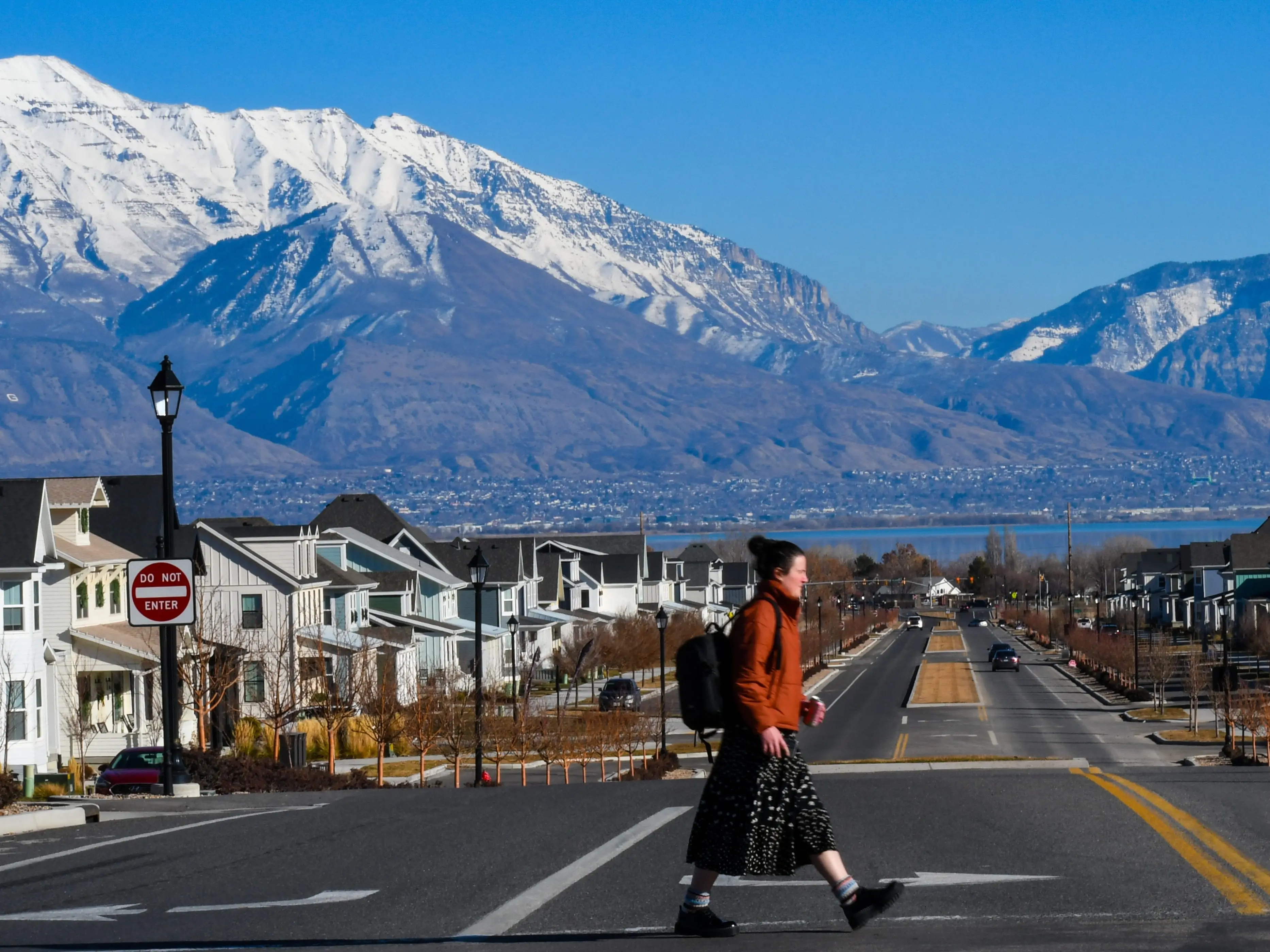 A Brigham Young University student crossing a street on August 15, 2024 in Provo, Utah, United States. BYU is a private research university founded in 1875.