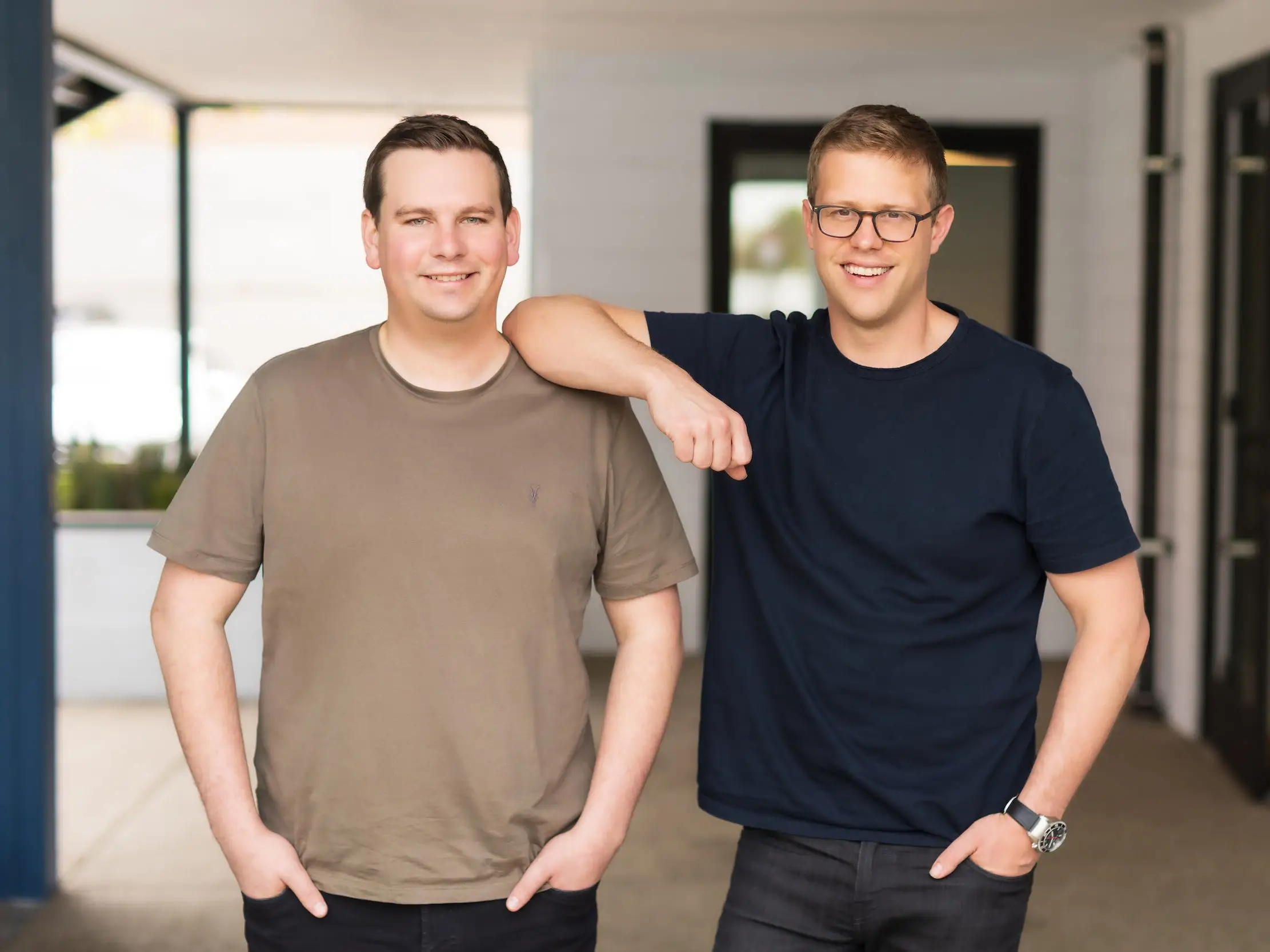 Whatnot cofounders Logan Head and Grant LaFontaine pose for a photo in an office setting.