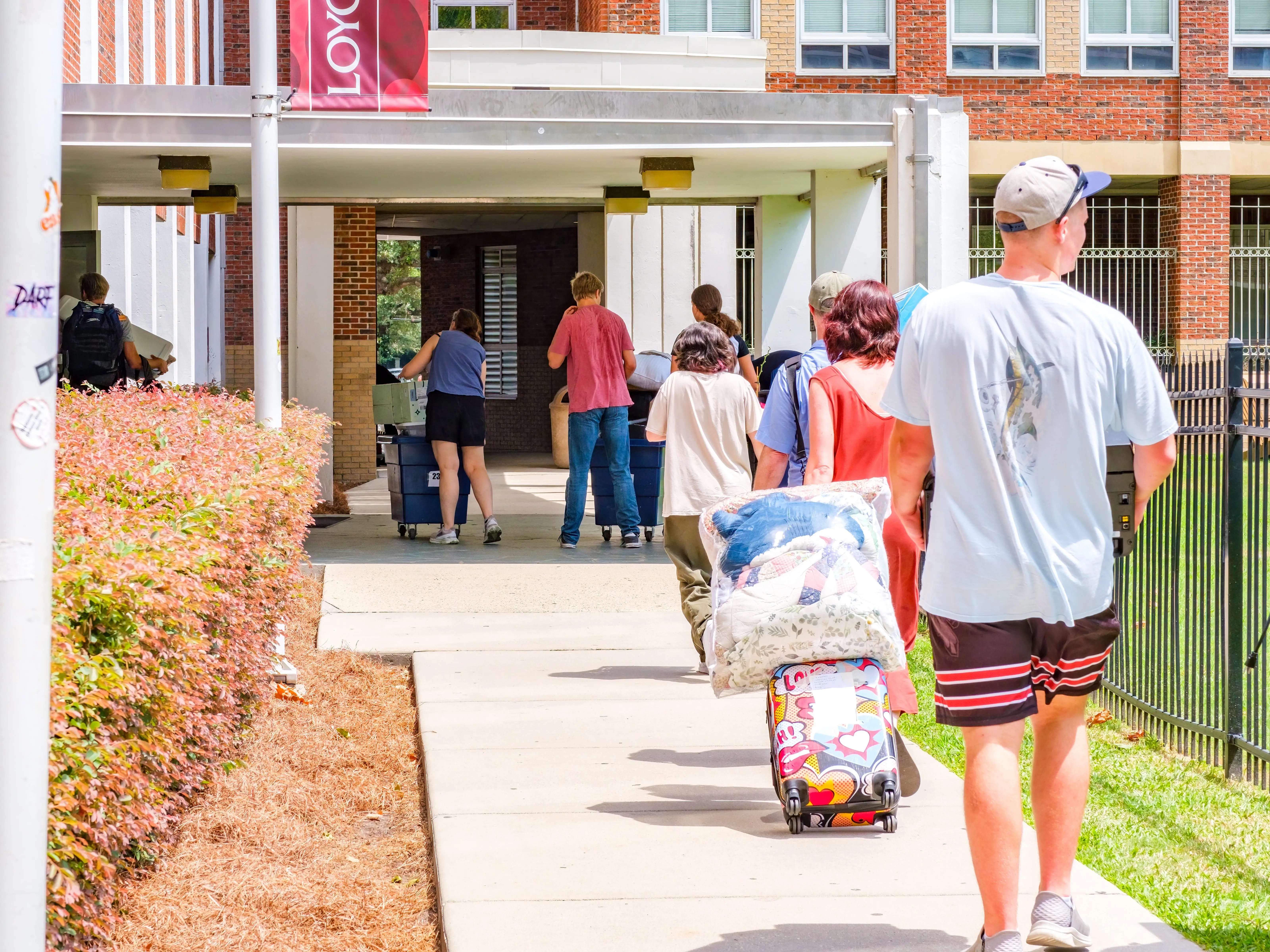 Parents and students moving into a dorm on the Loyola University campus for the fall semester