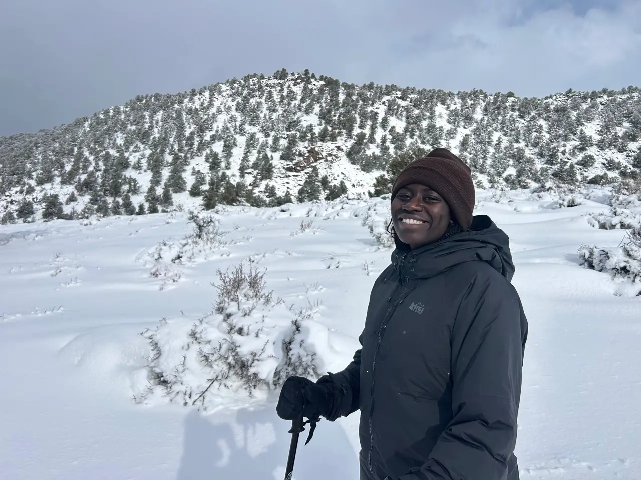 Author Alicia Simba wearing coat smiling in snow