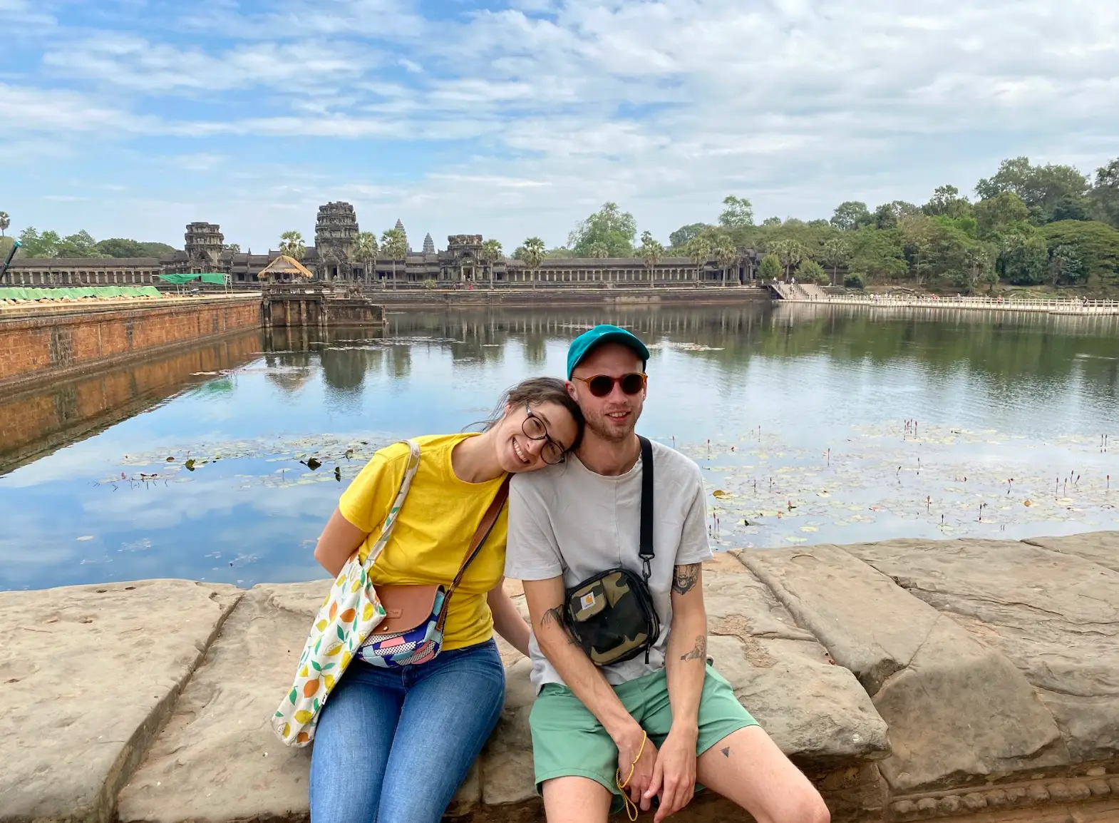 The writer and her husband posing in front of the water.