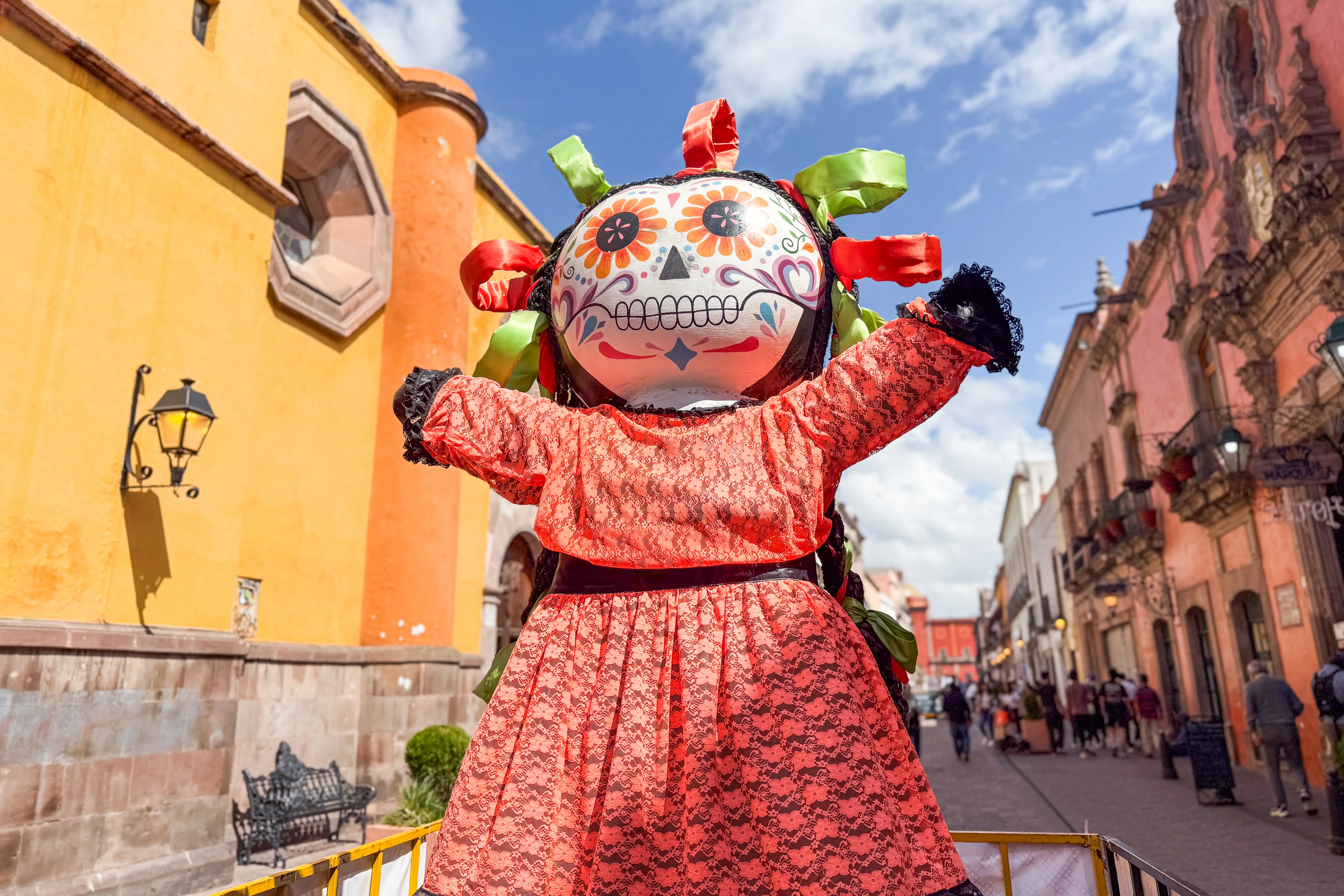 Figure with sugar skull head and colorful dress