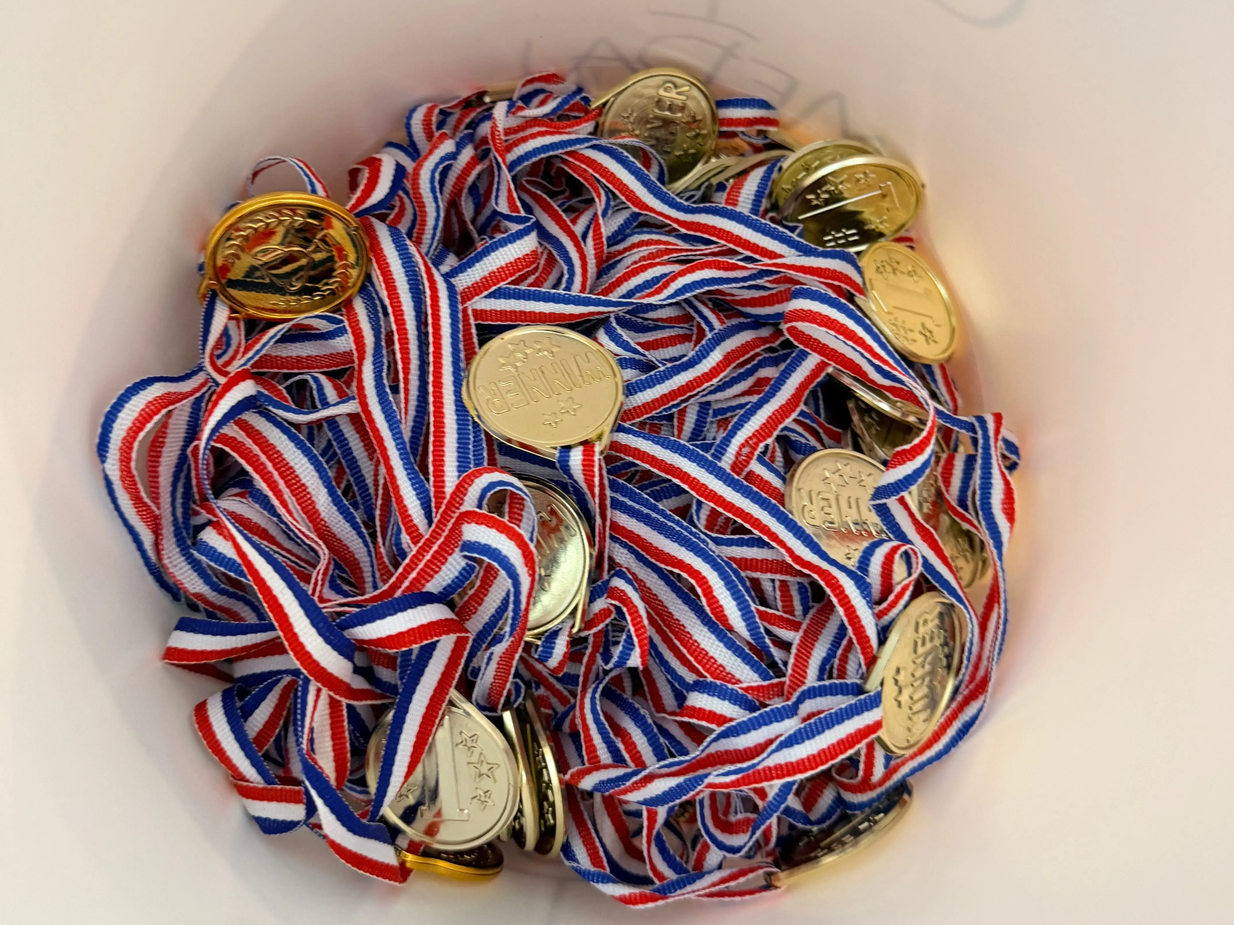 Bucket full of toy gold medals