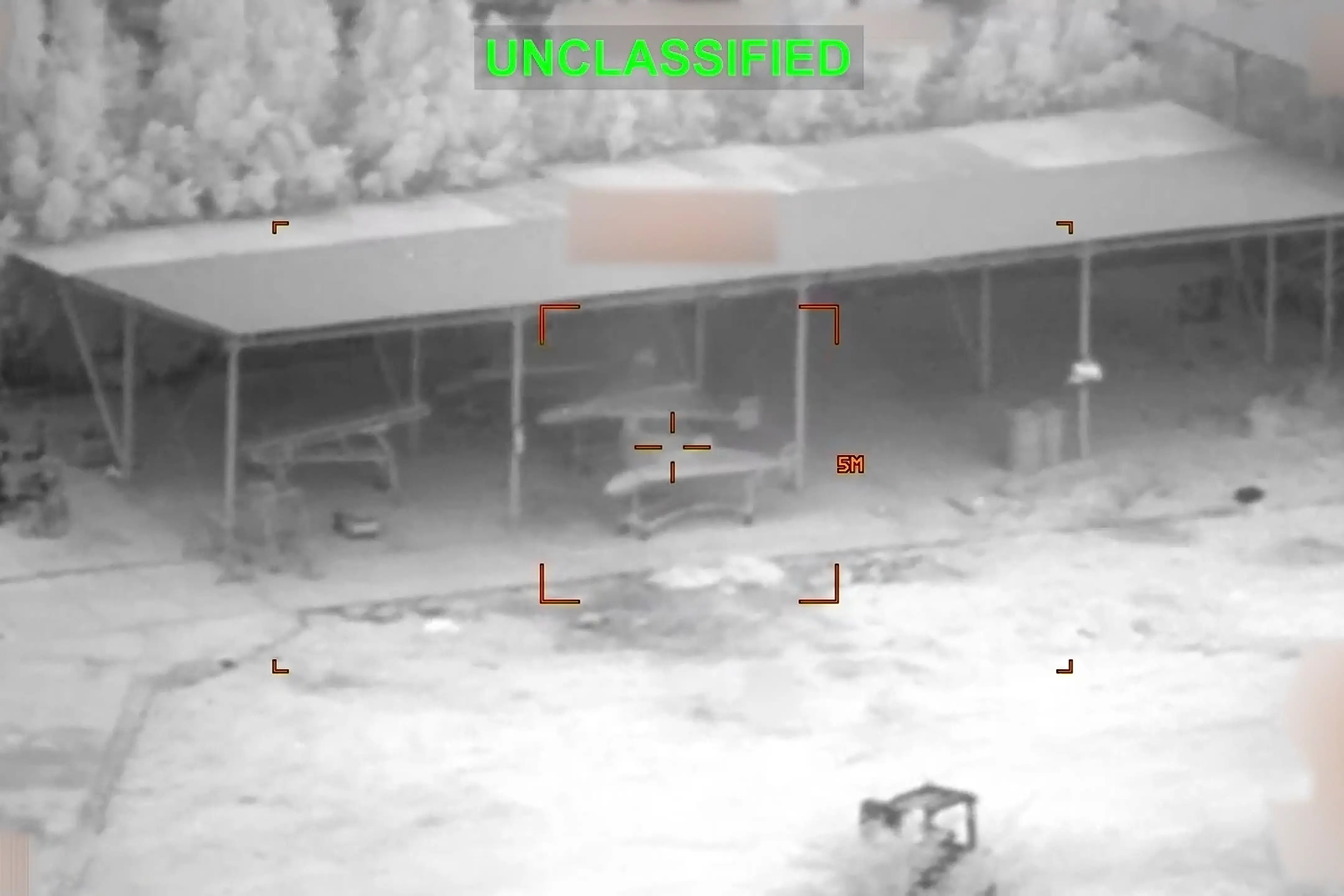 This partially redacted image from a video provided by US Central Command shows military drones in Iran shortly before they were struck by a missile fired by US forces on Sunday, March 1, 2026.