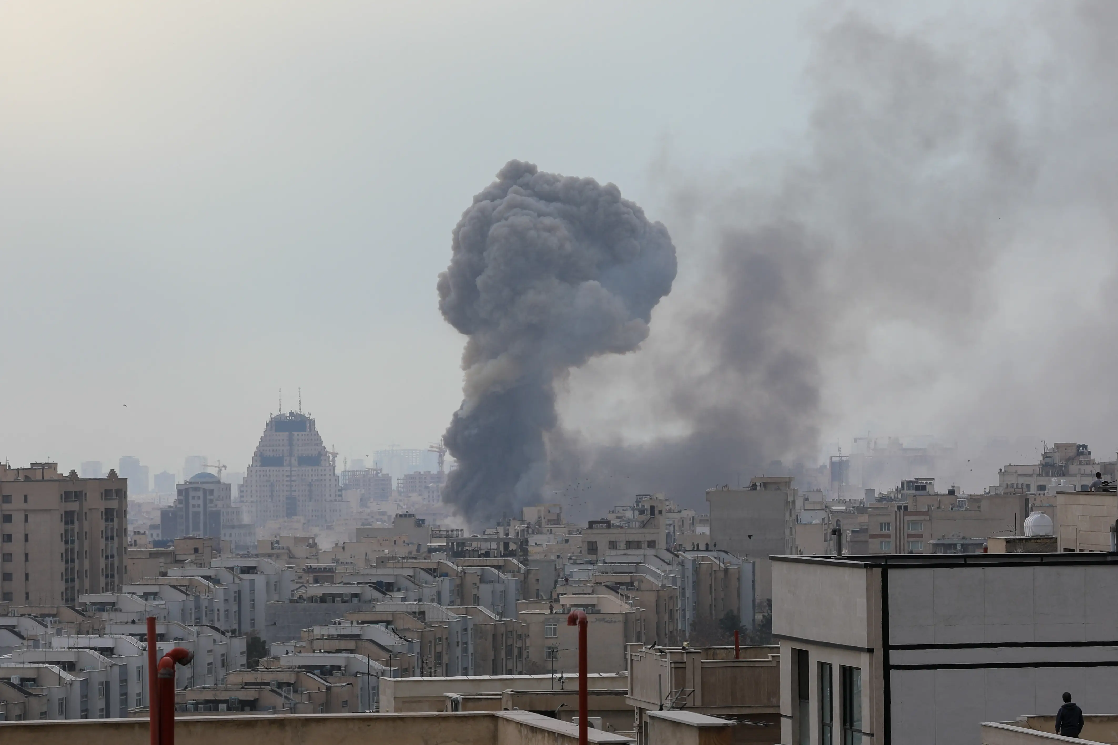 Plumes of smoke rise following reported explosions in Tehran on March 2, 2026, after Iran's supreme leader, Ayatollah Ali Khamenei, was killed on February 28, in a large US and Israeli attack, prompting a new wave of retaliatory missile strikes from Iran.