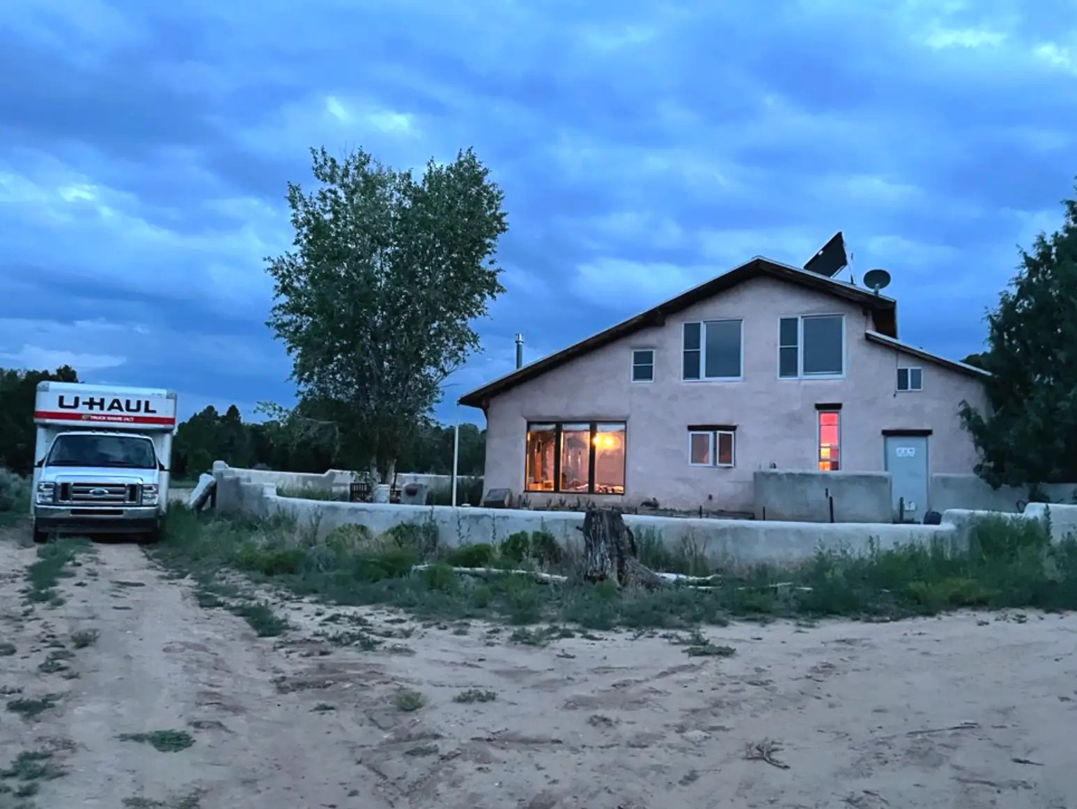 The writer's off-grid home in New Mexico, with a U-Haul truck nearby.