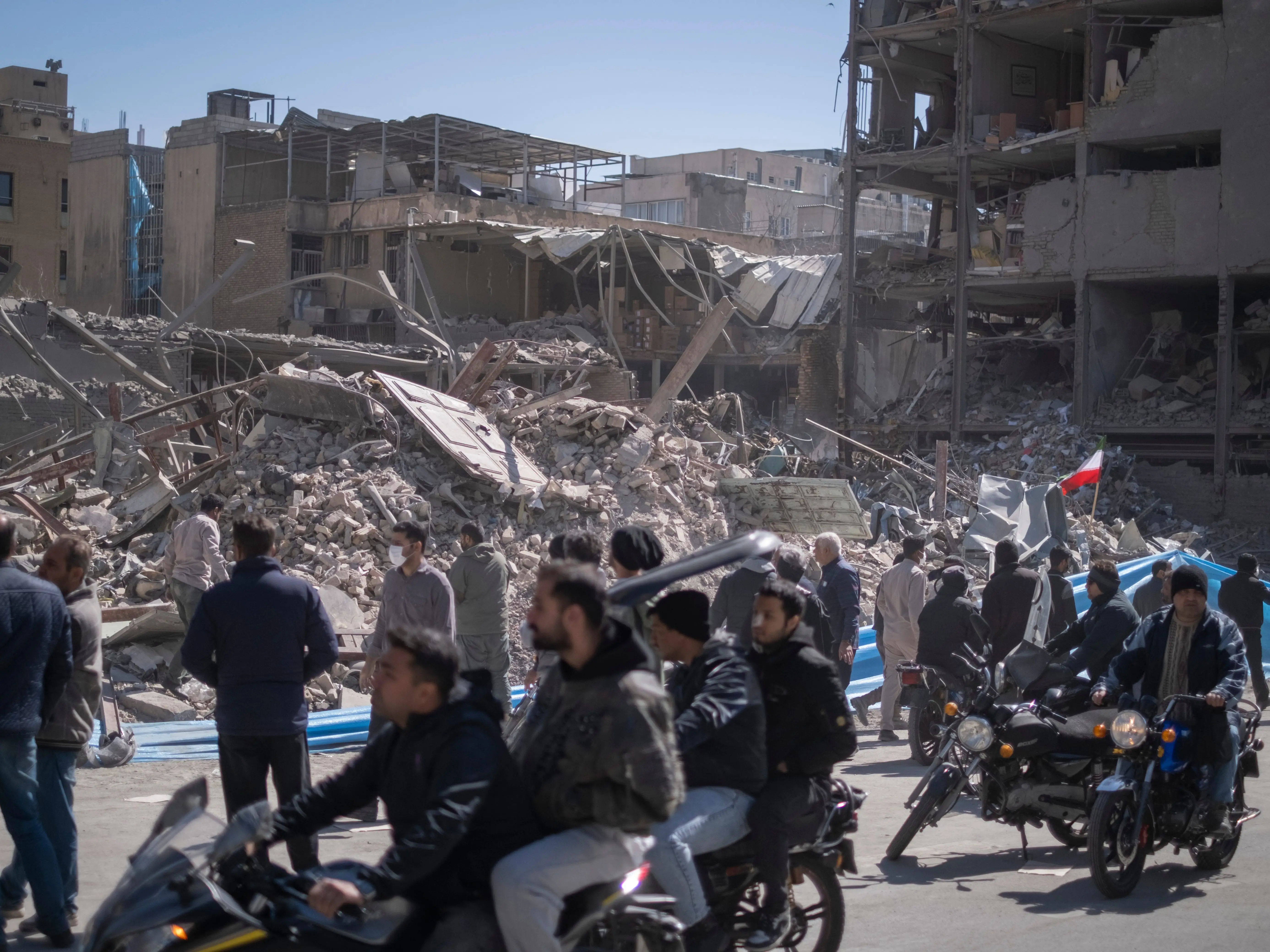 People gather in front of the ruins of a police station that is struck during U.S.-Israeli attacks in Tehran, Iran, on March 3, 2026.