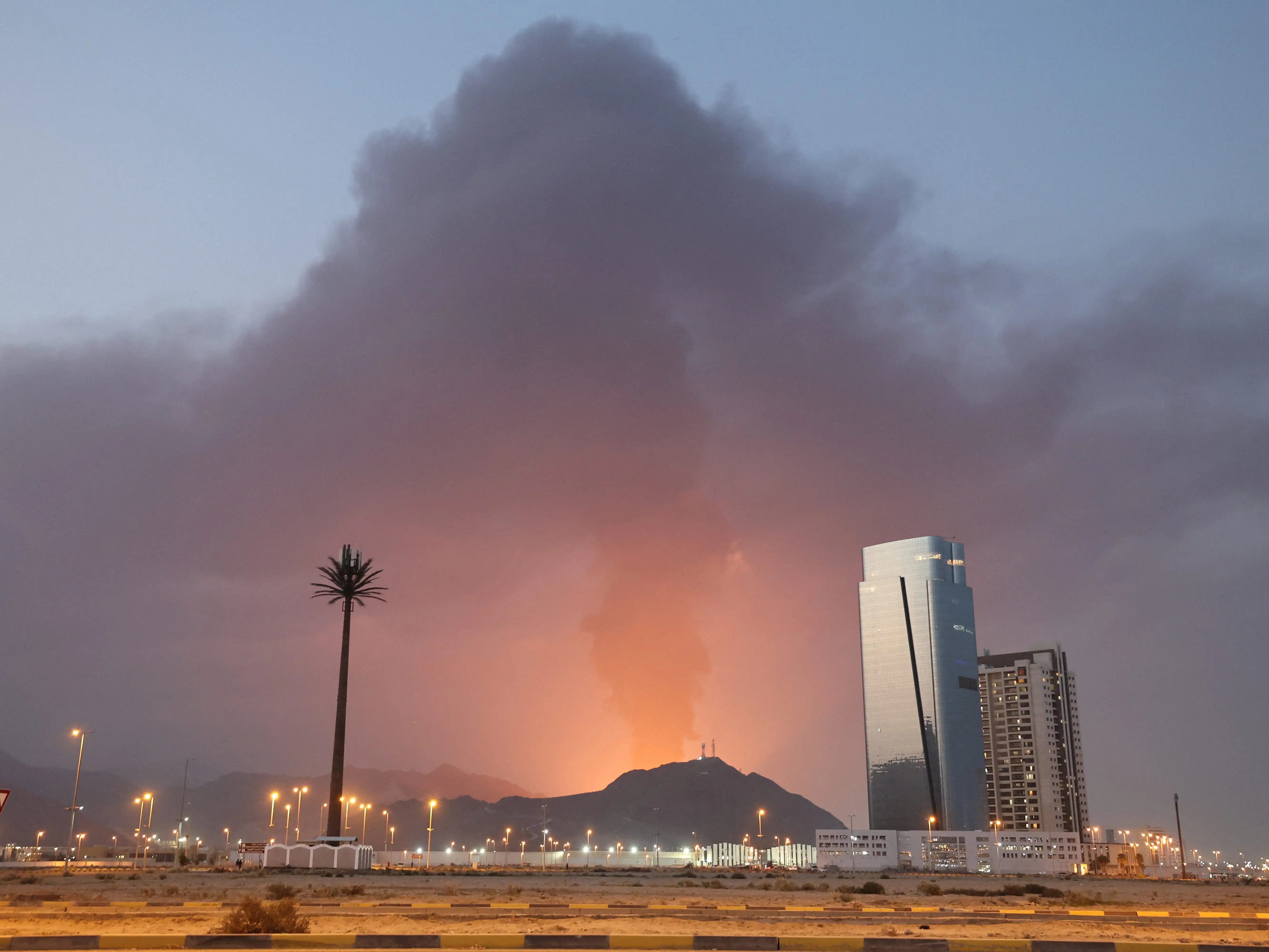 A tall plume of black smoke ascends following an explosion in the Fujairah industrial zone on March 3, 2026. Iran's strikes on Gulf neighbours since February 28, following the US-Israeli attack, forced the UAE to shut its airspace, blindsiding travellers who thought they were headed to one of the region's safest holiday destinations.