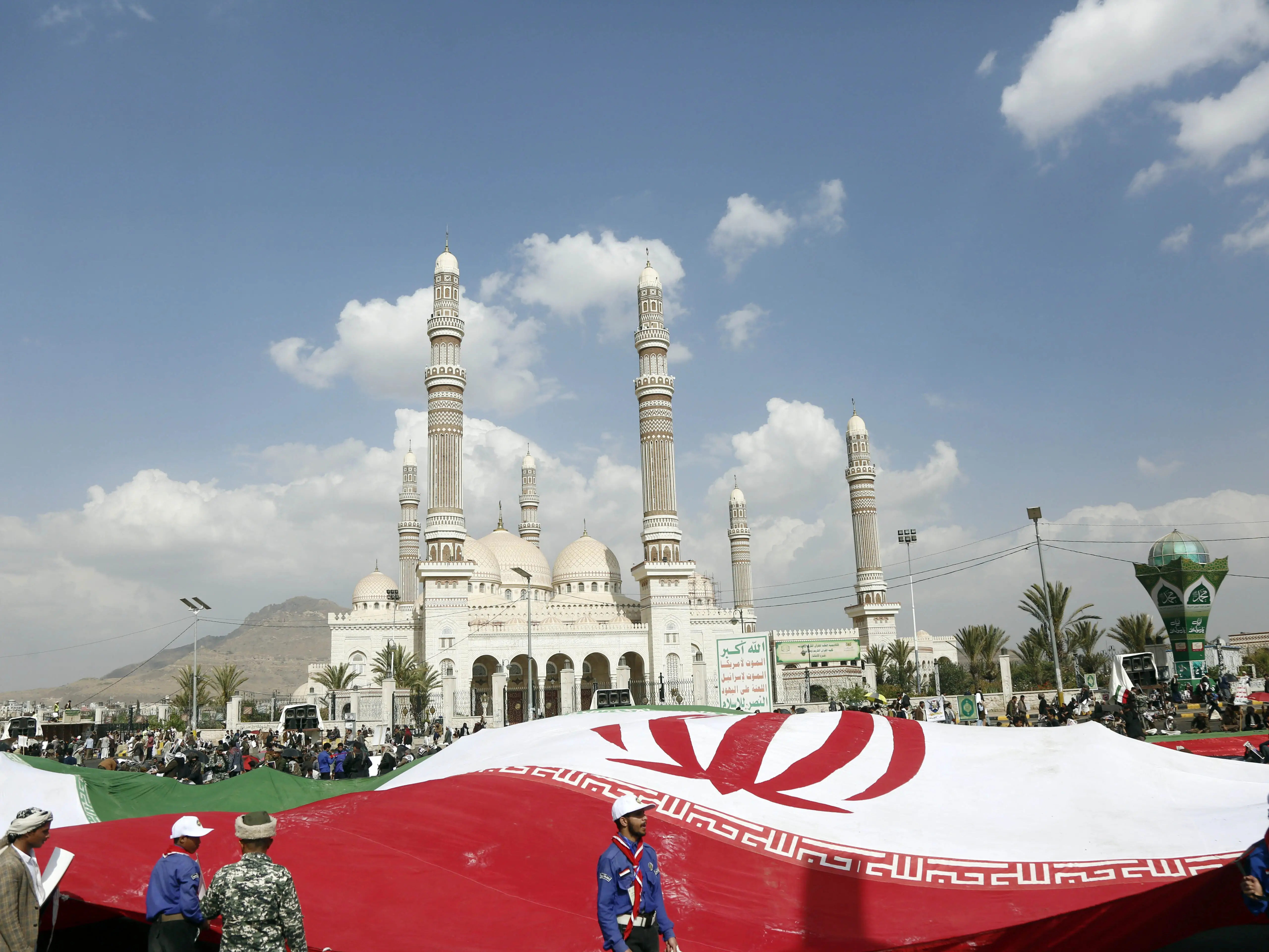 Pro-Iran protesters hold a large flag of Iran as they take part in a rally held to condemn the US-Israel aerial attacks on Iran and killing the Iranian Supreme leader and several military officials on March 1, 2026 in Sana'a, Yemen.