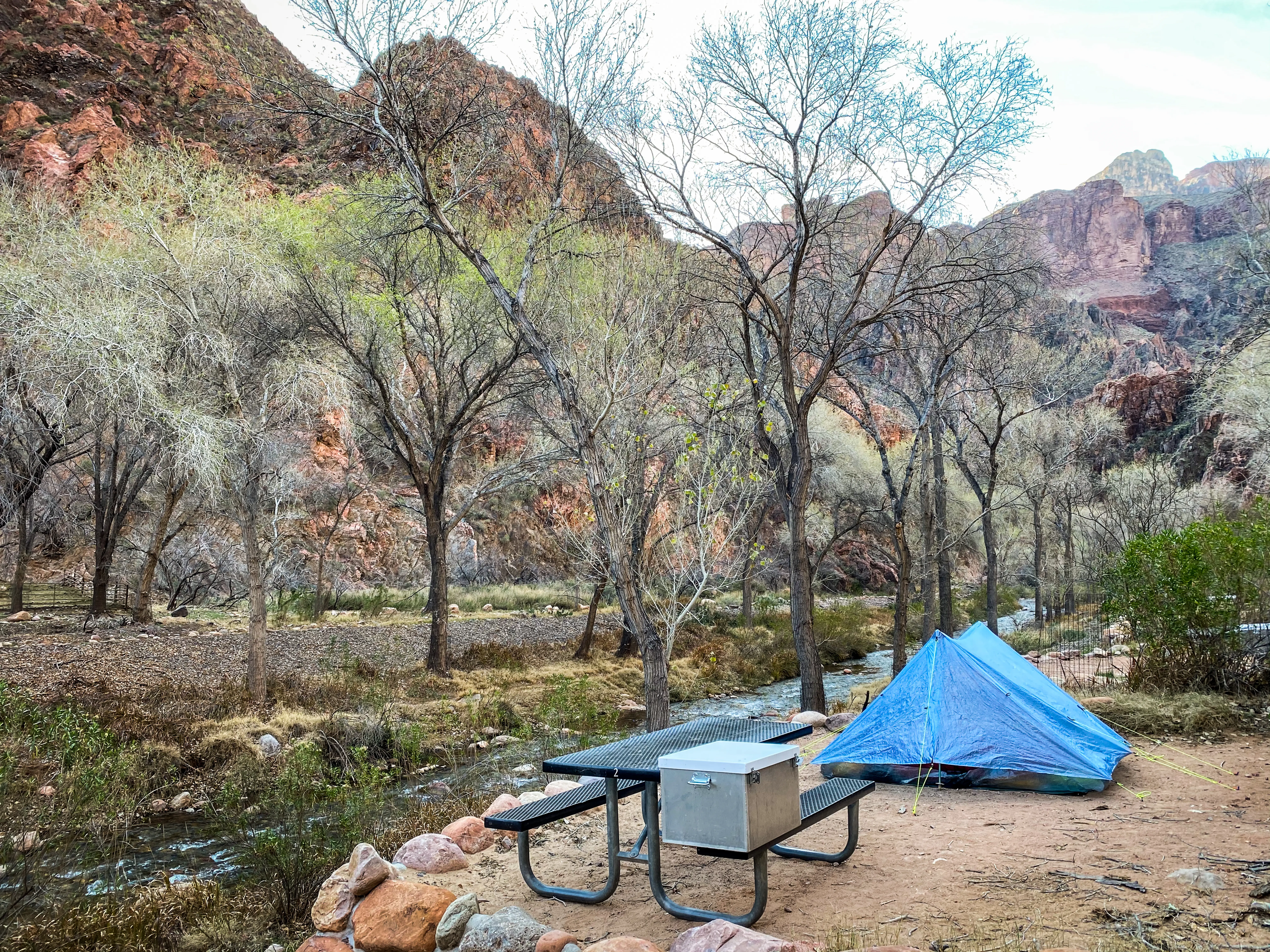 Tent and table with benches in Bright Angel Campground - Grand Canyon