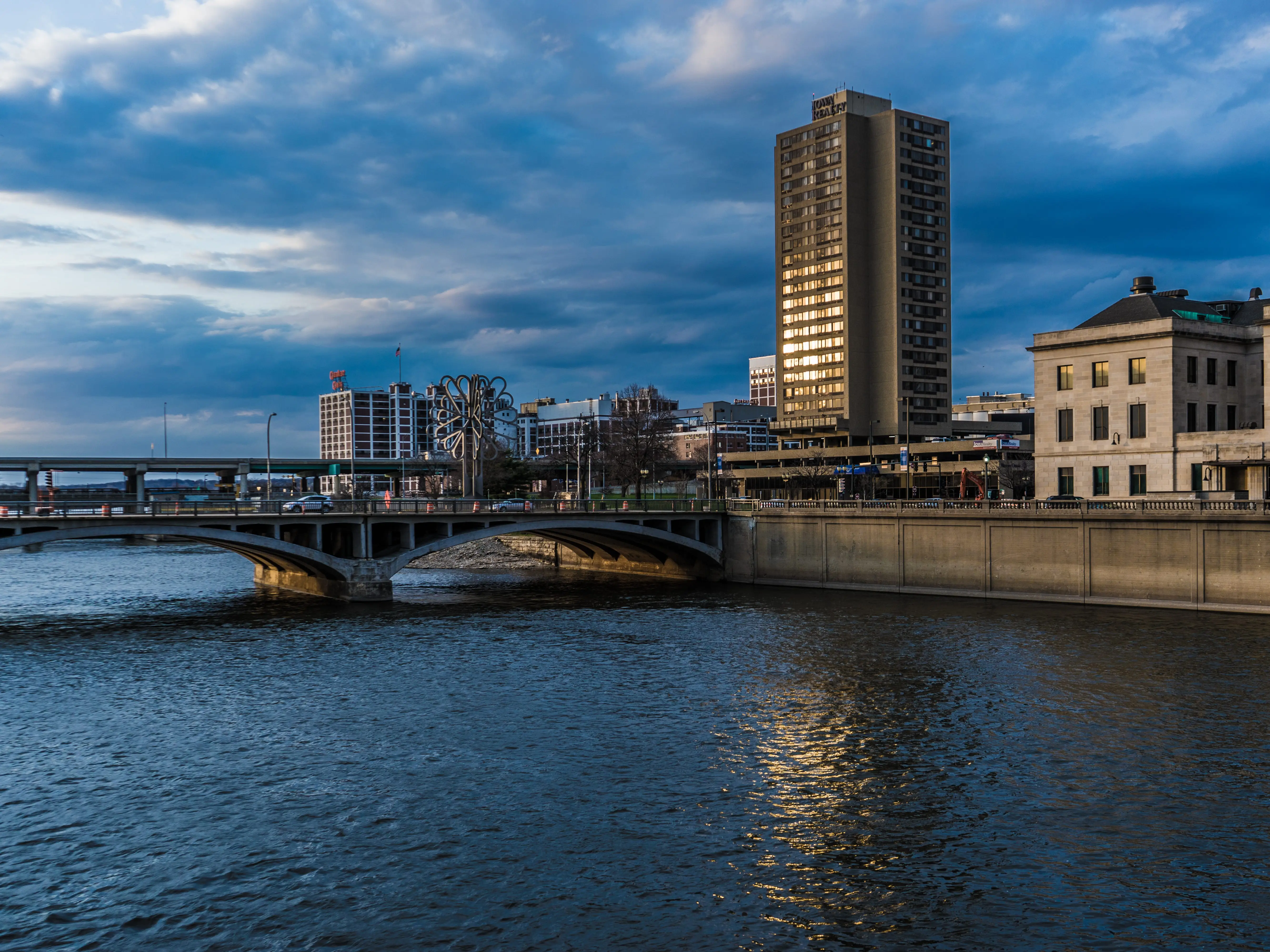 A bridge over a river with buildings.