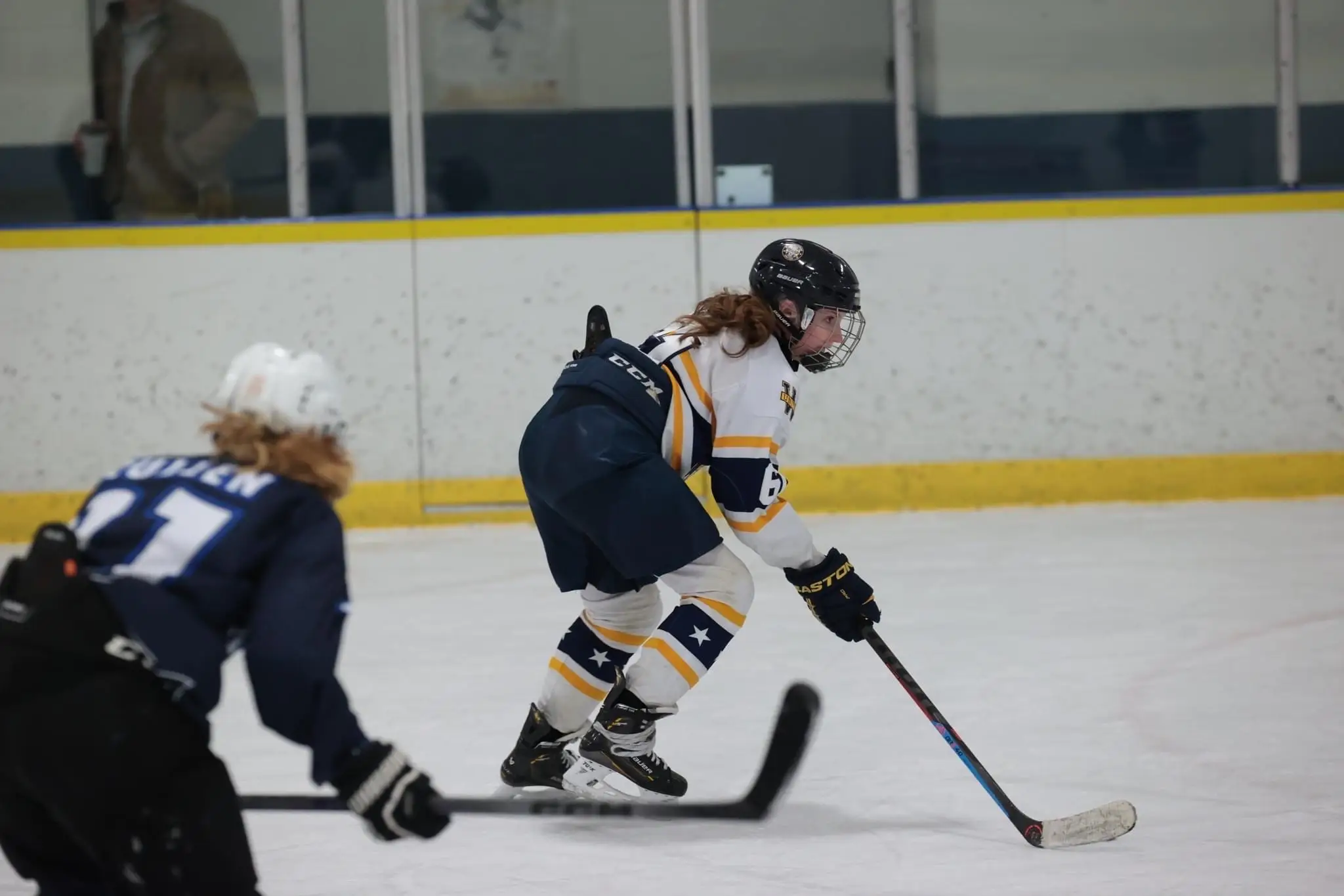 A young girl playing youth hockey.