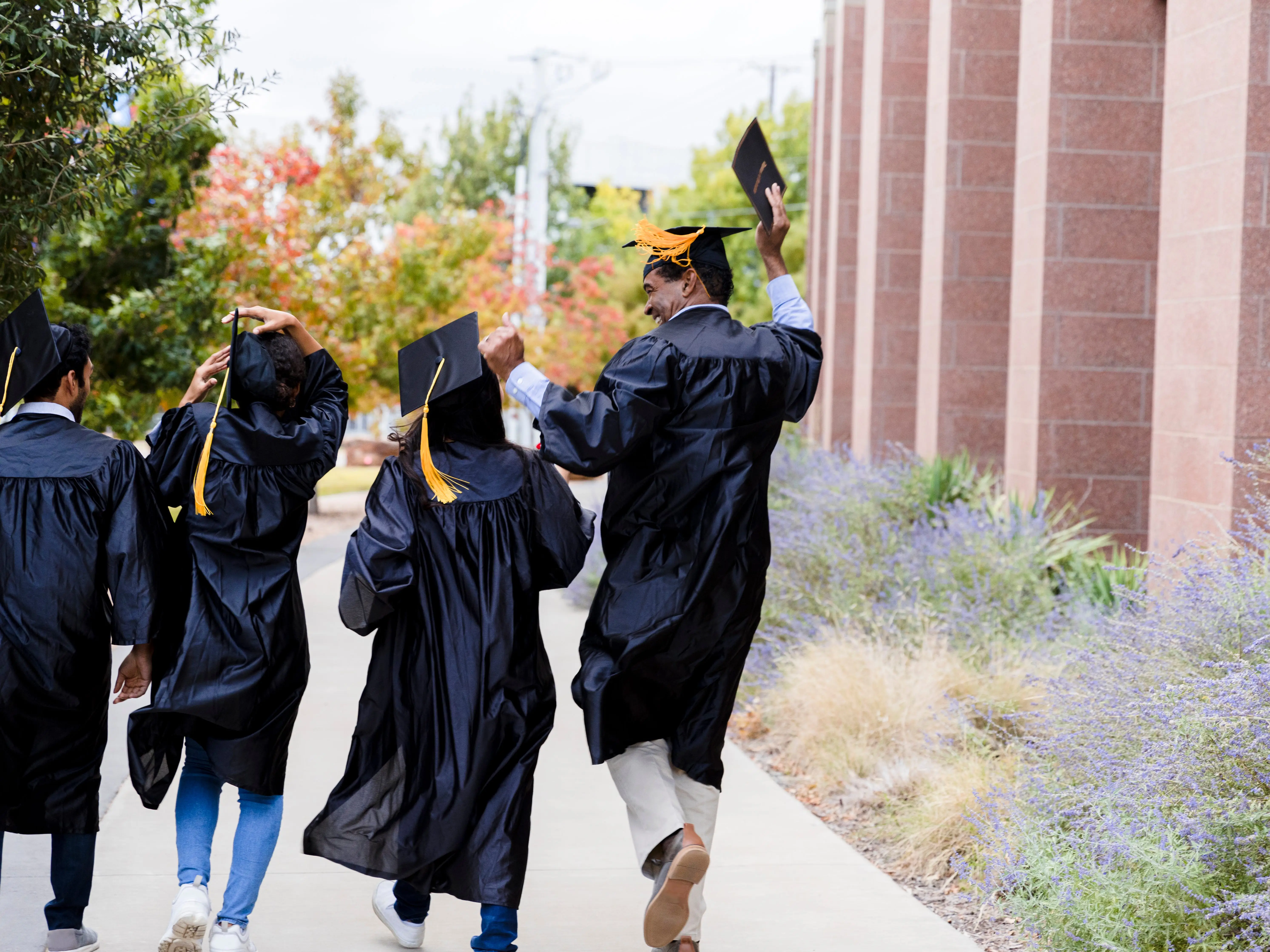 Graduates wearing caps and gowns outside