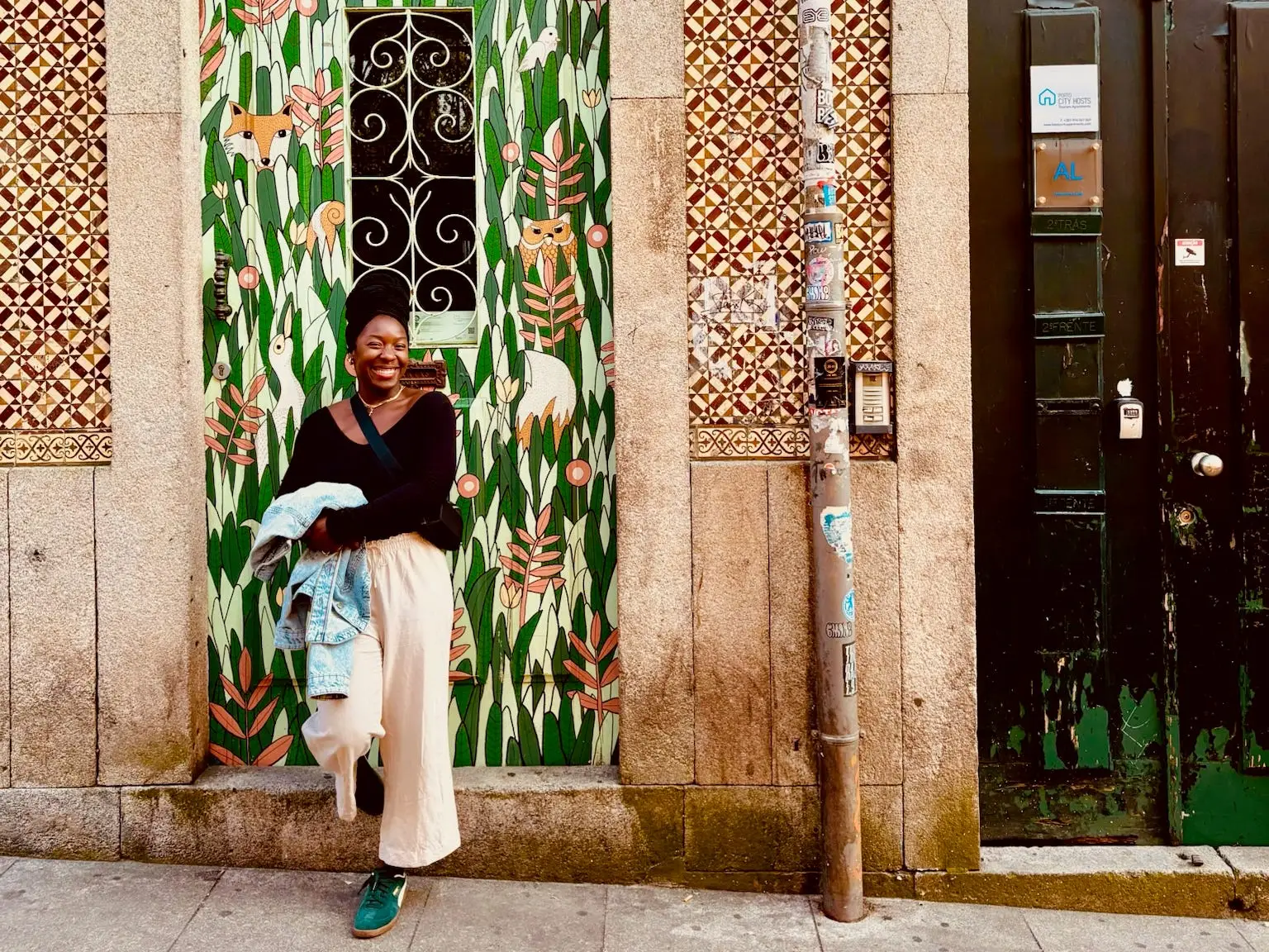 Woman smiling against colorful door