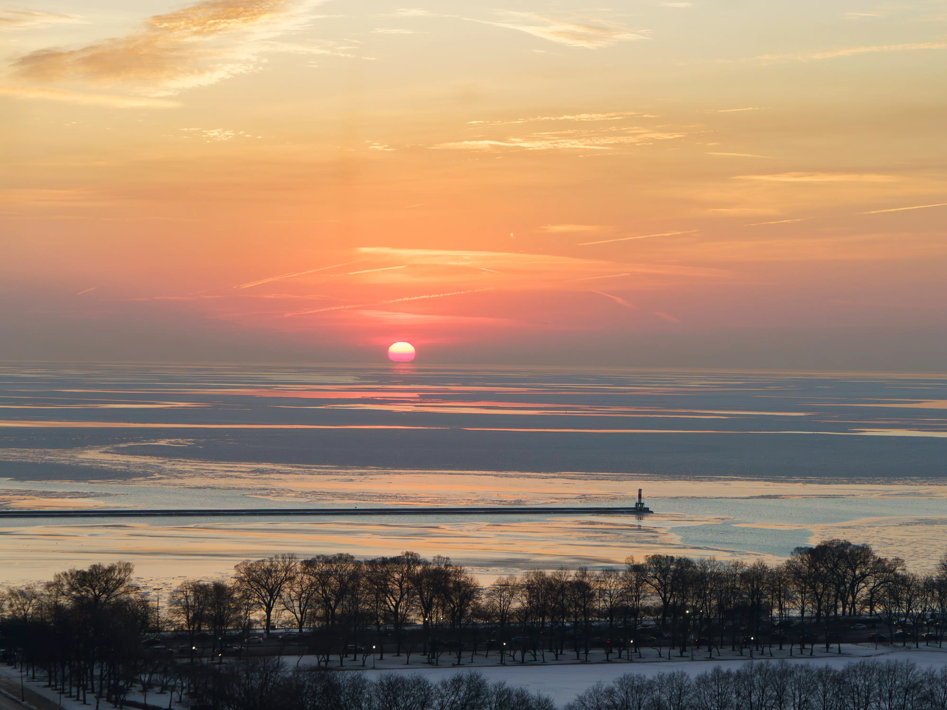 The sun rises over the lake in Chicago