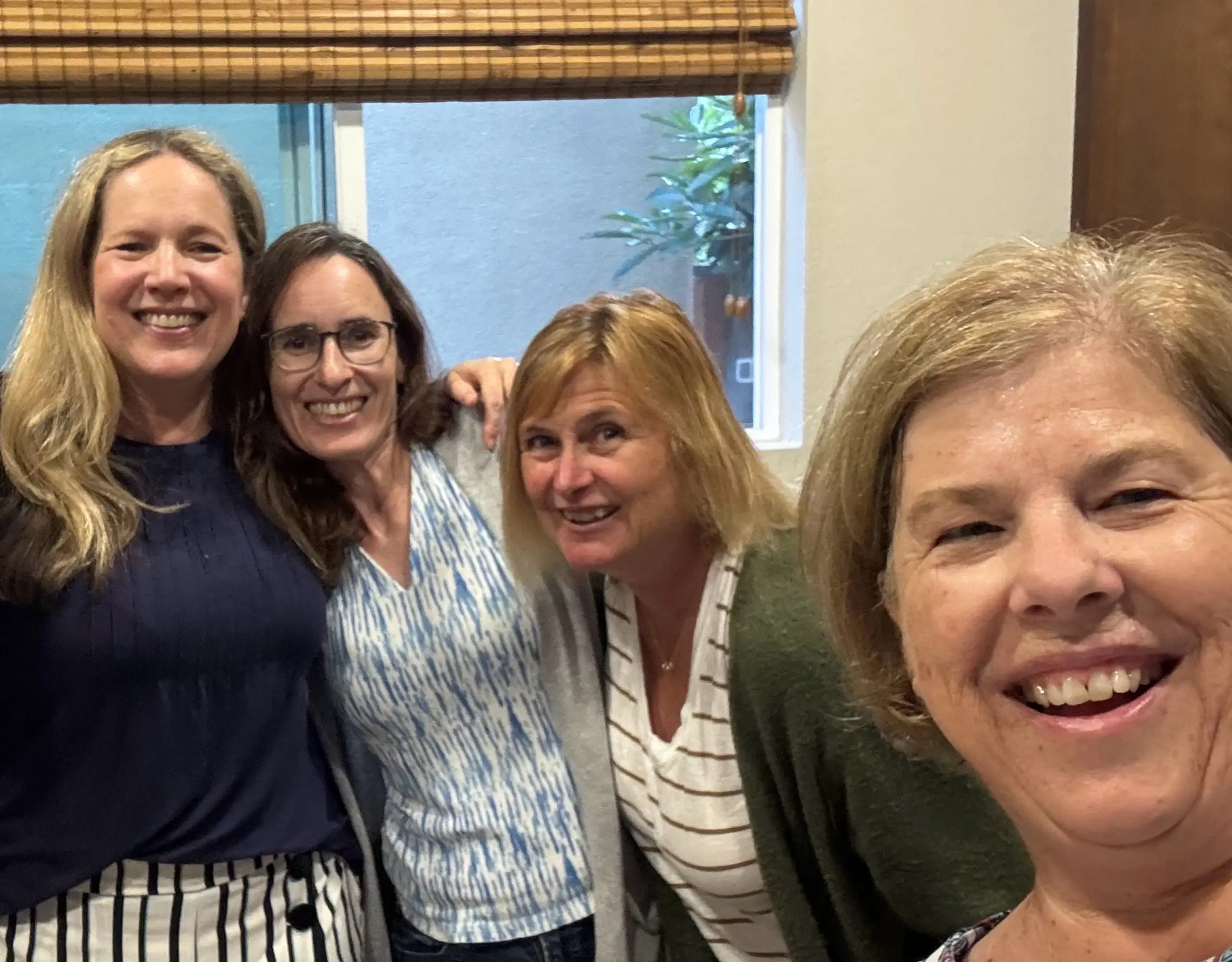 A group of four women in their 50s.