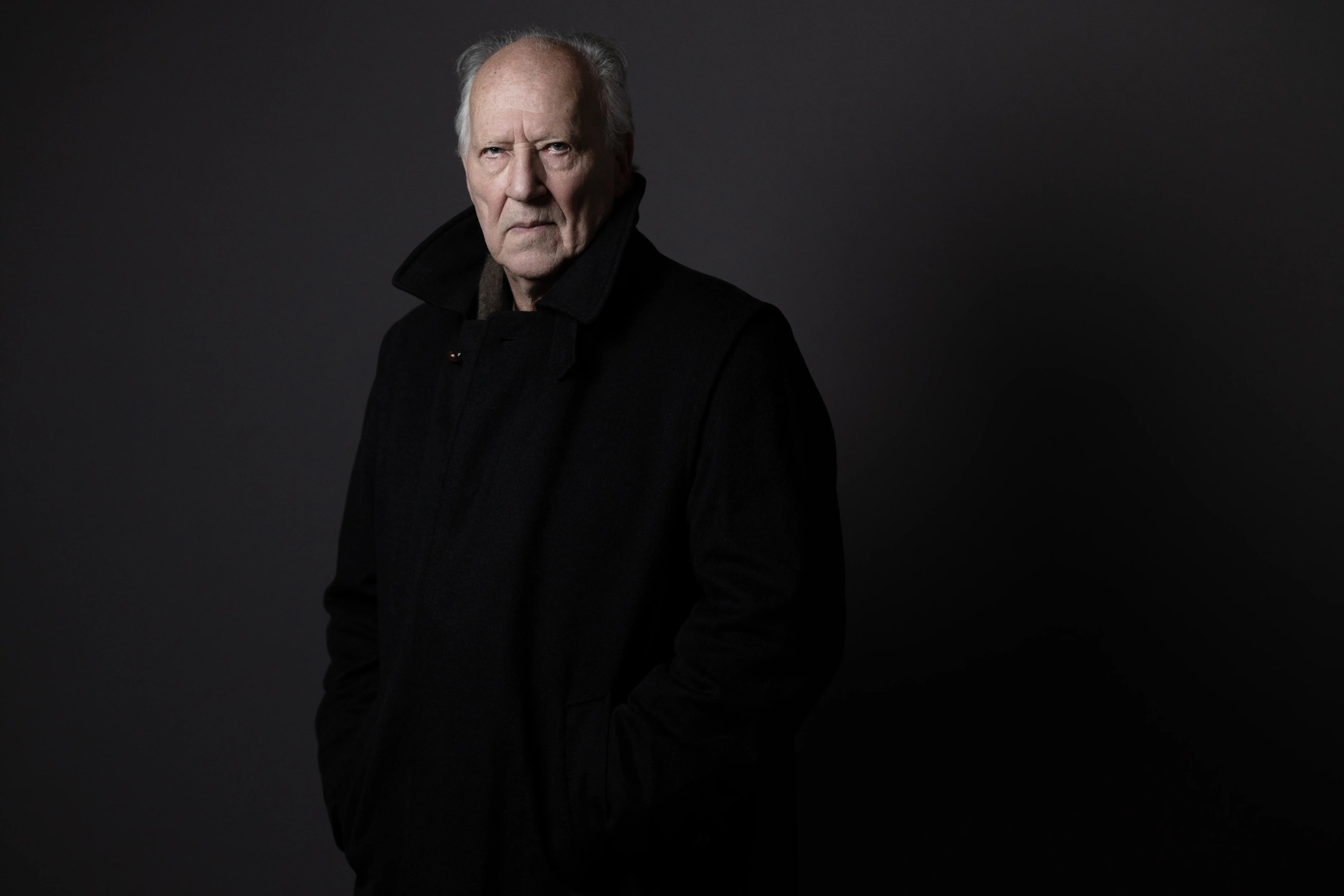 Werner Herzog in a black coat