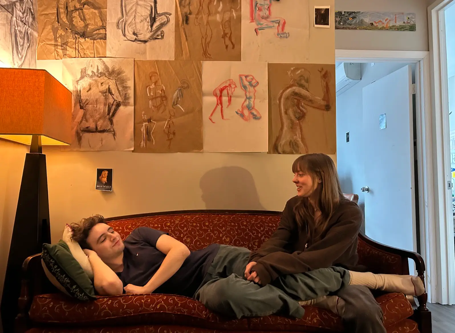 The writer and her boyfriend sitting on the couch in their apartment's common area.