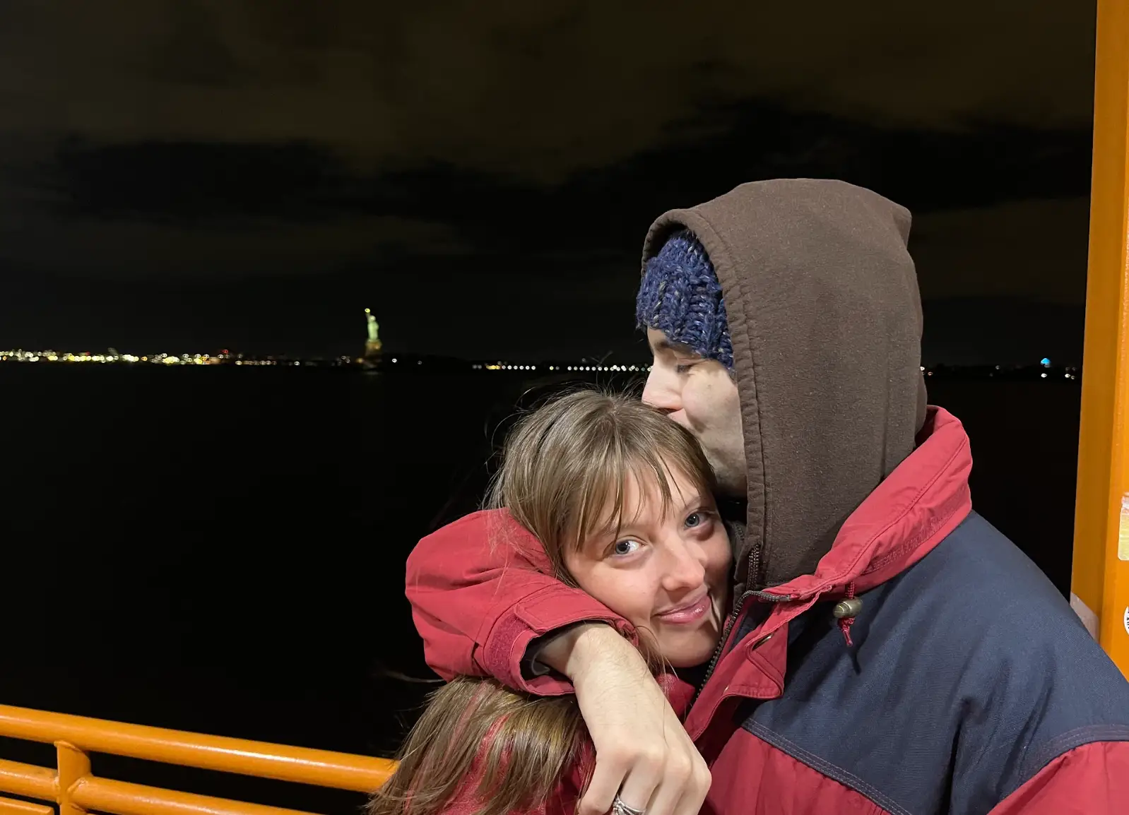 The writer and her boyfriend kissing on the Staten Island Ferry, with the Statue of Liberty in the background.
